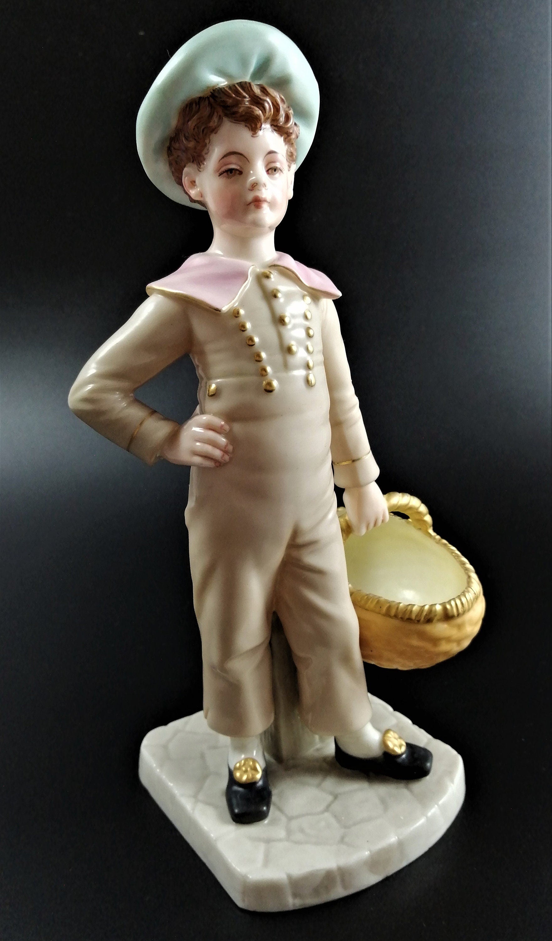Antique Royal Worcester,boy with basket,modelled by James Hadley.