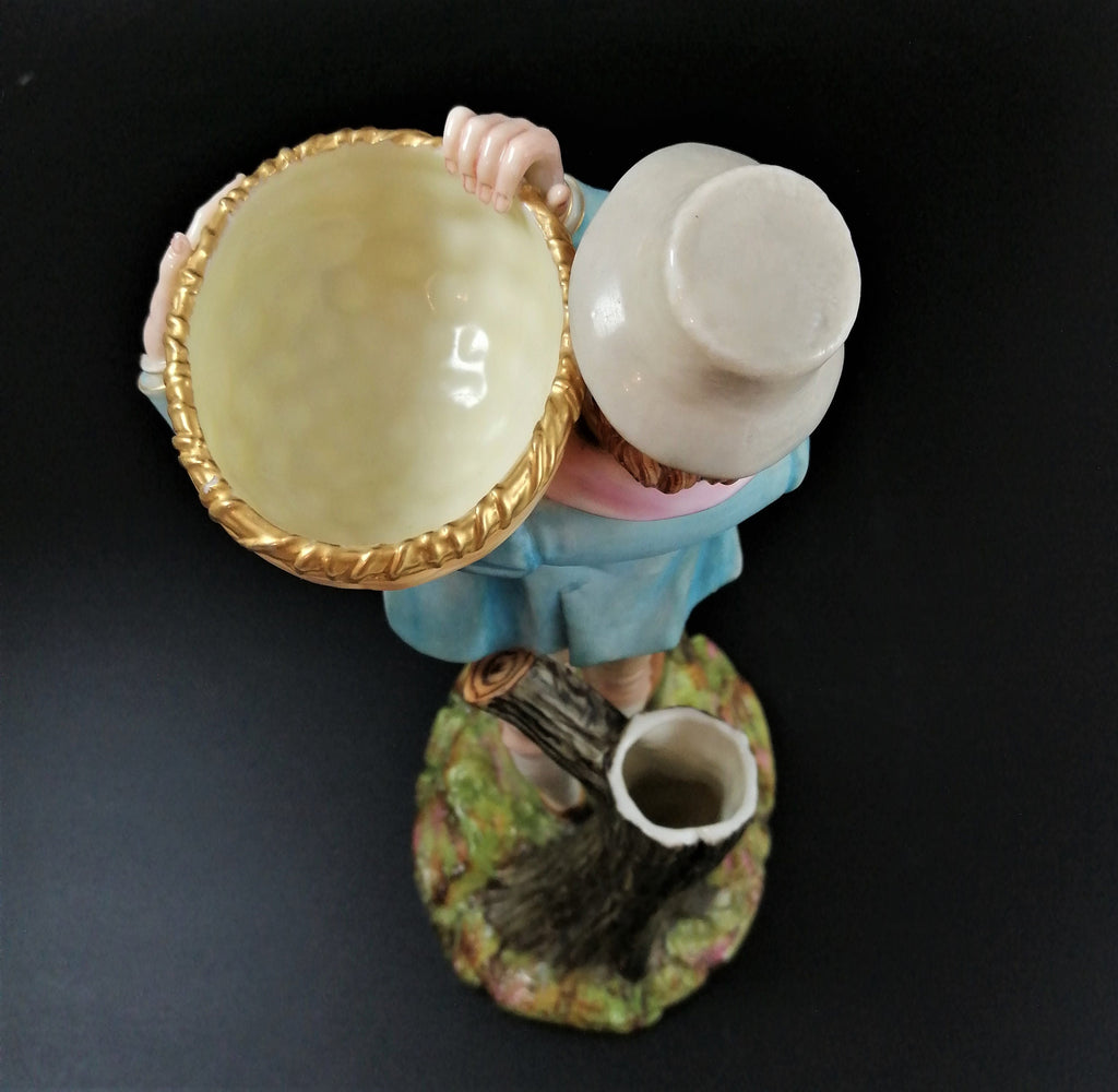 Antique Royal Worcester figural spill holder,of boy carrying basket,James Hadley