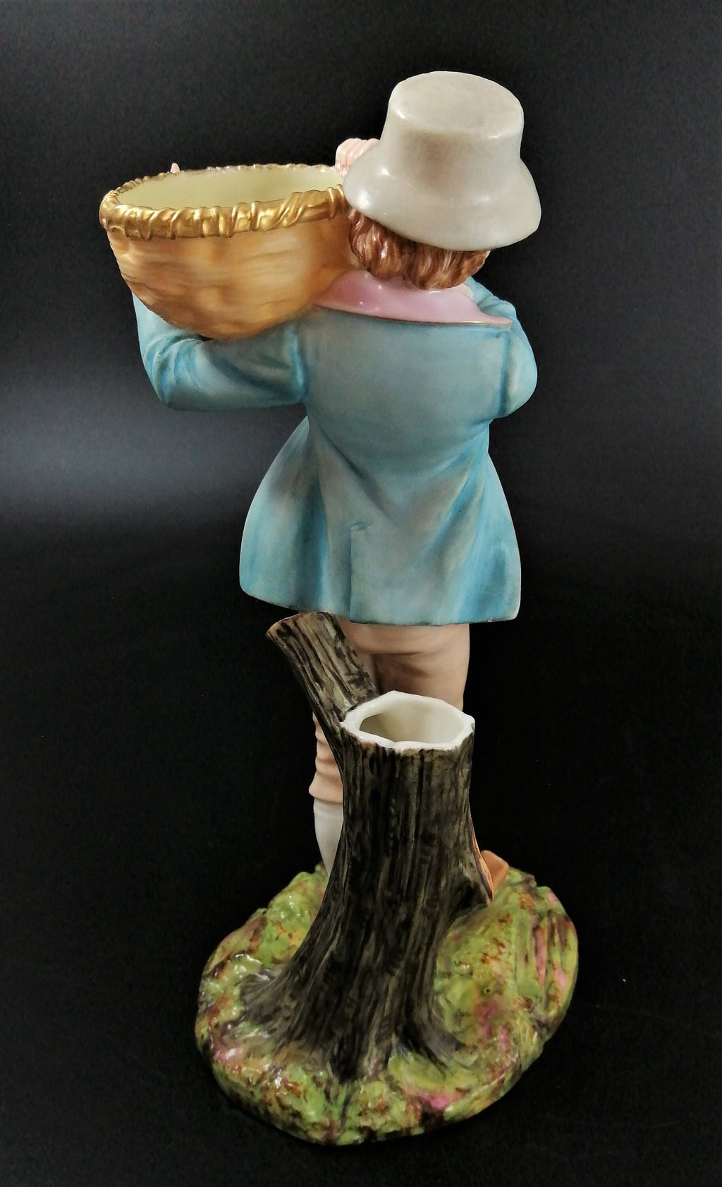 Antique Royal Worcester figural spill holder,of boy carrying basket,James Hadley