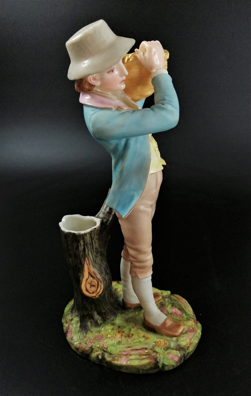 Antique Royal Worcester figural spill holder,of boy carrying basket,James Hadley