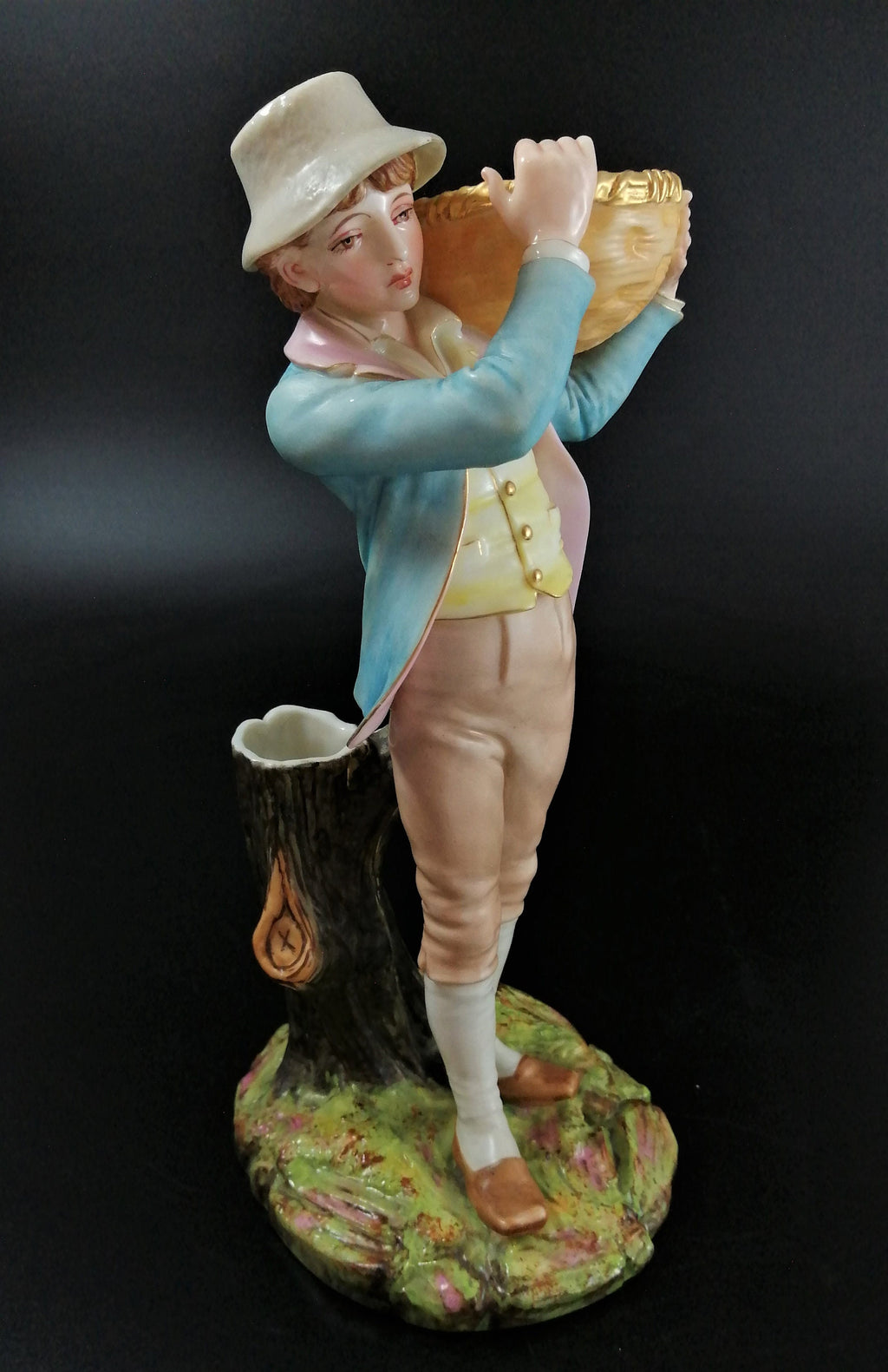 Antique Royal Worcester figural spill holder,of boy carrying basket,James Hadley