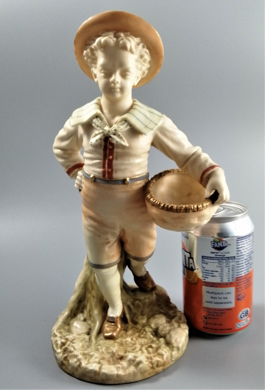 Antique Royal Worcester,boy with basket,modelled by James Hadley.
