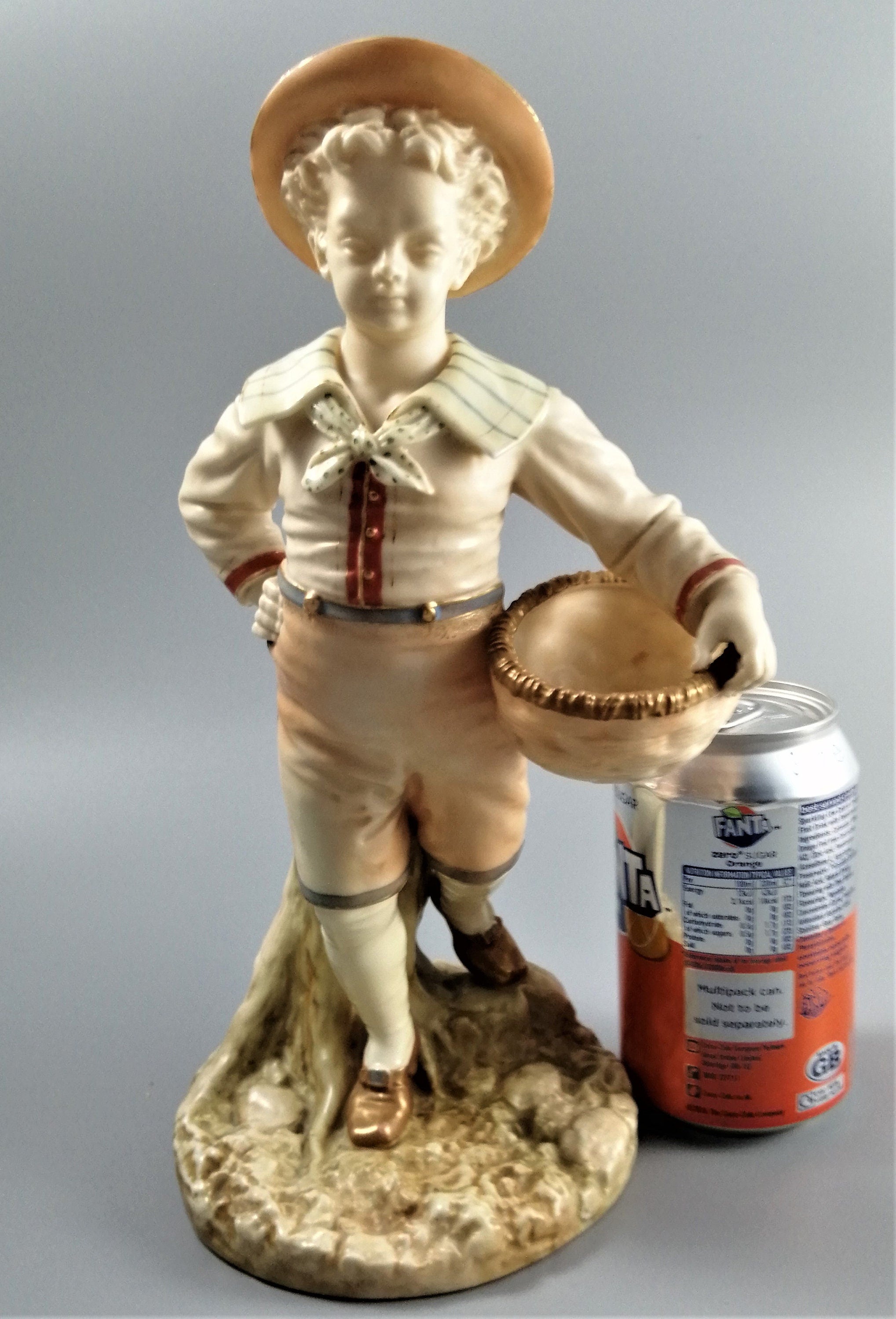 Antique Royal Worcester,boy with basket,modelled by James Hadley.