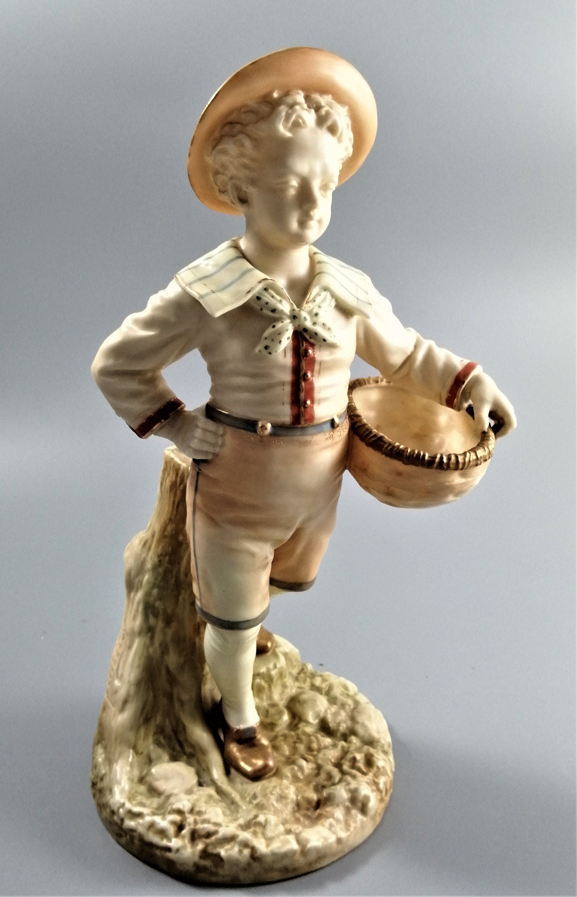 Antique Royal Worcester,boy with basket,modelled by James Hadley.