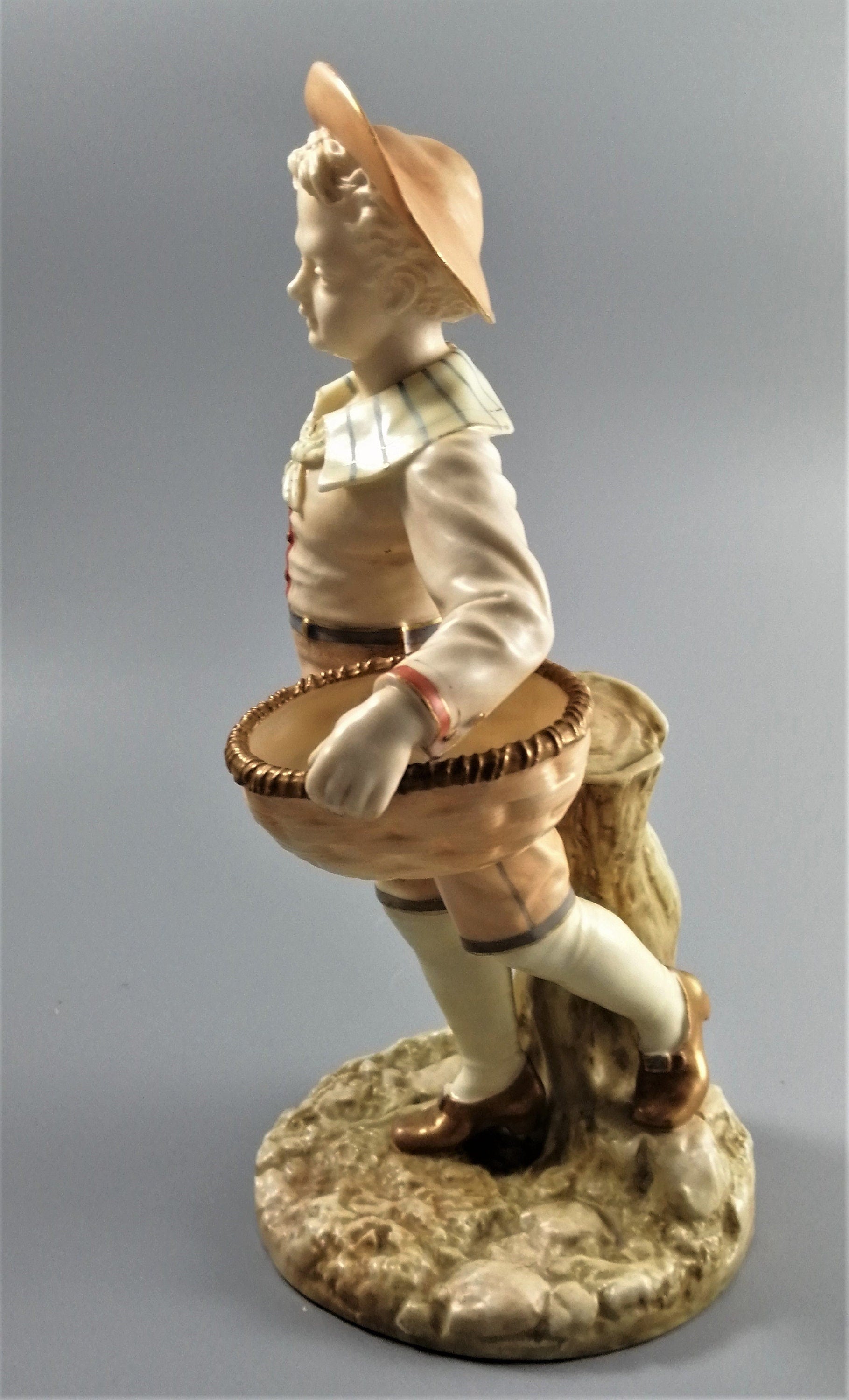 Antique Royal Worcester,boy with basket,modelled by James Hadley.