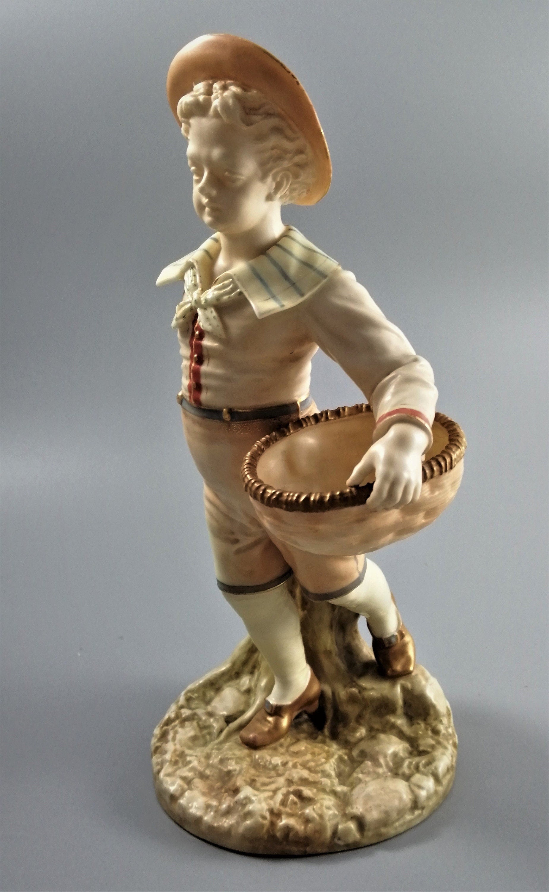 Antique Royal Worcester,boy with basket,modelled by James Hadley.