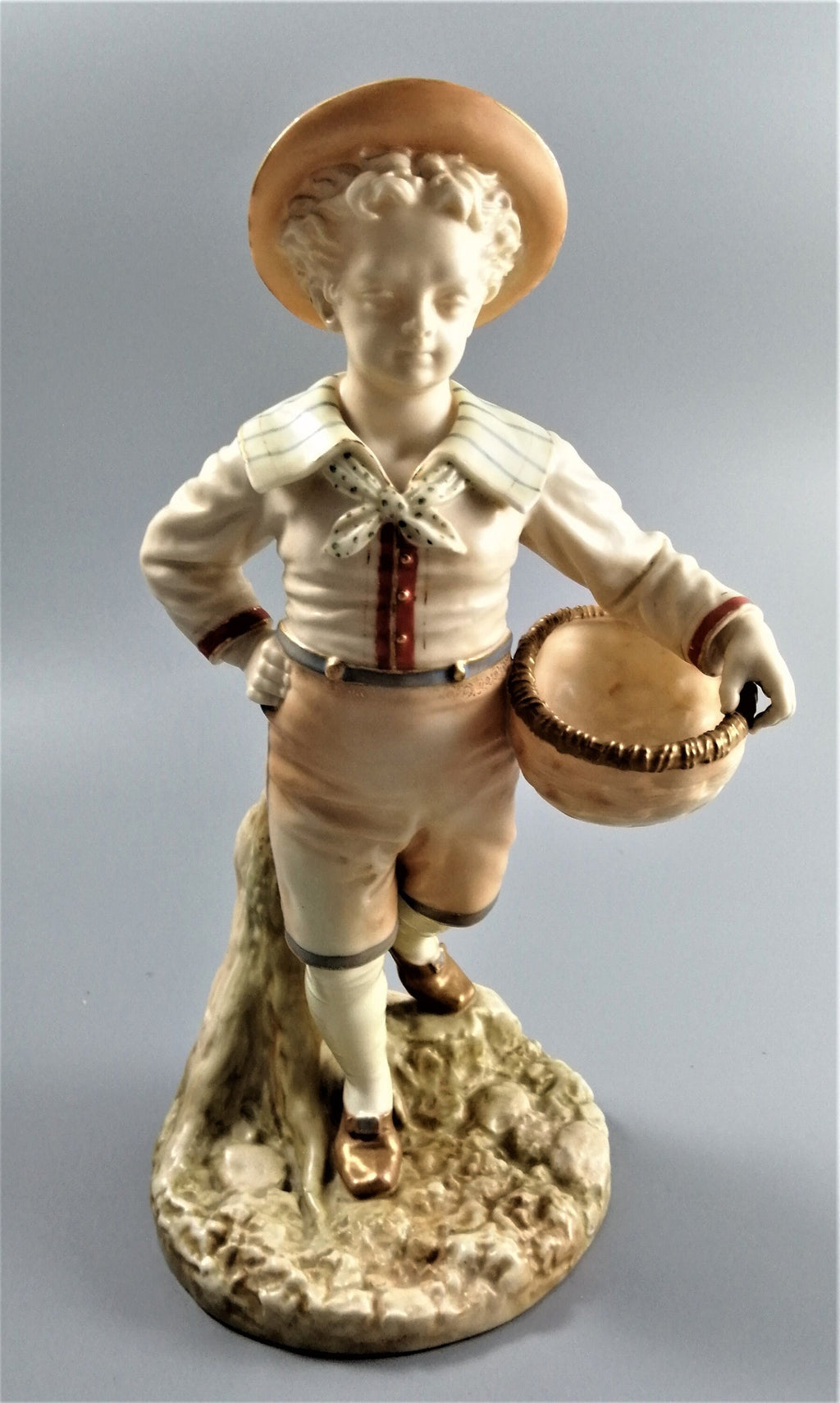 Antique Royal Worcester,boy with basket,modelled by James Hadley.