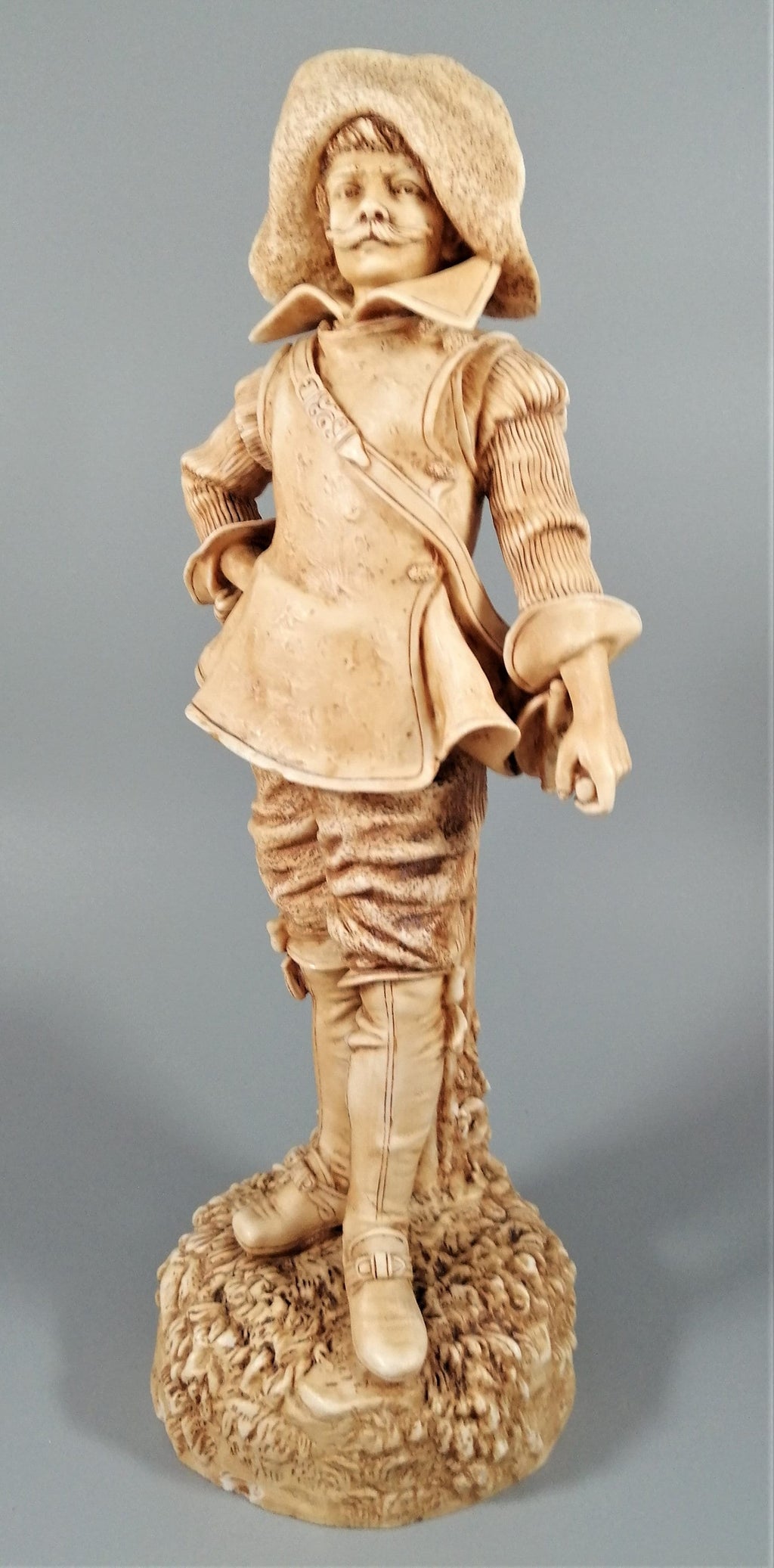 A Robinson and Leadbeater ivory parian ware figure of a musketeer