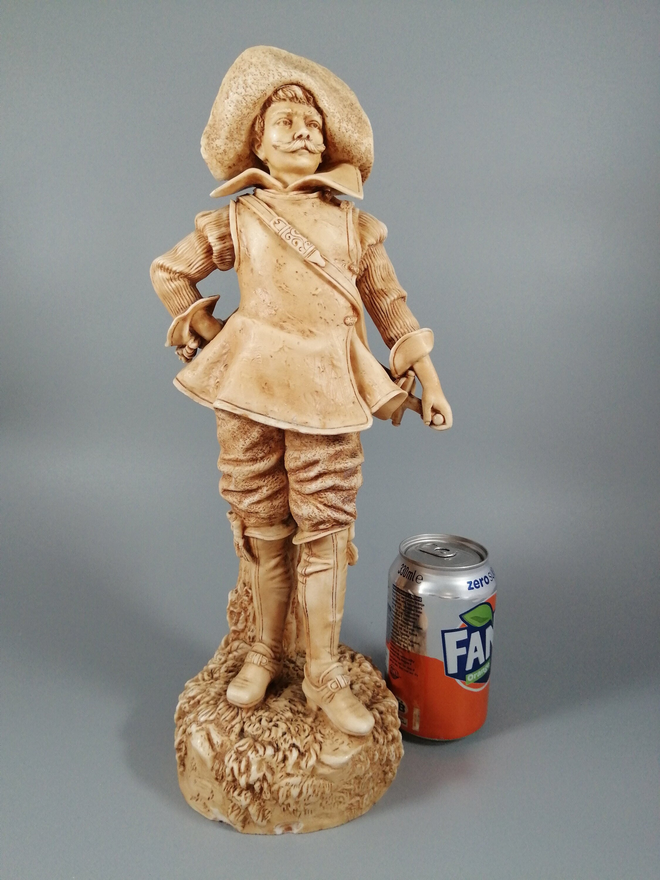 A Robinson and Leadbeater ivory parian ware figure of a musketeer