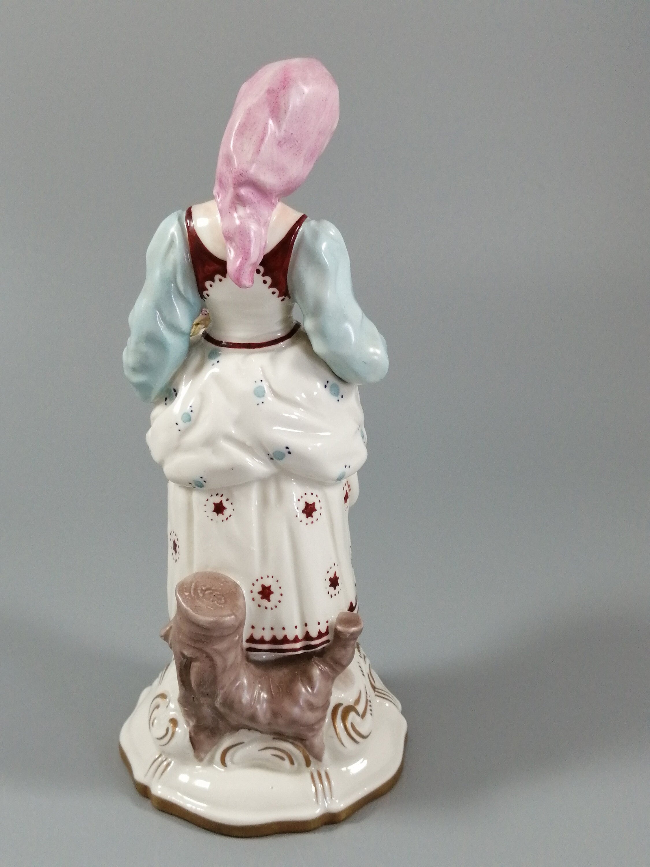 Antique porcelain figurine marked with the crossed swords of Meissen
