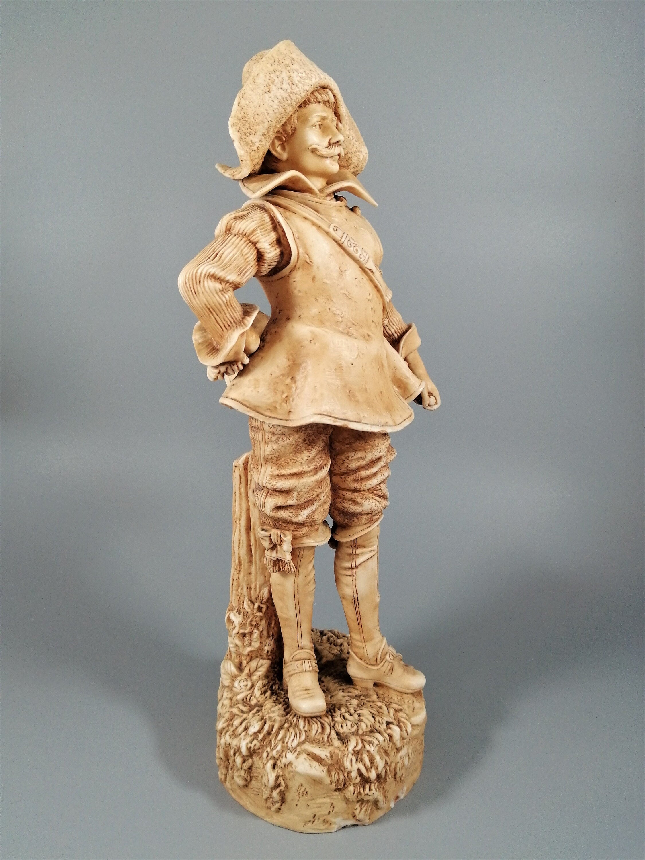 A Robinson and Leadbeater ivory parian ware figure of a musketeer
