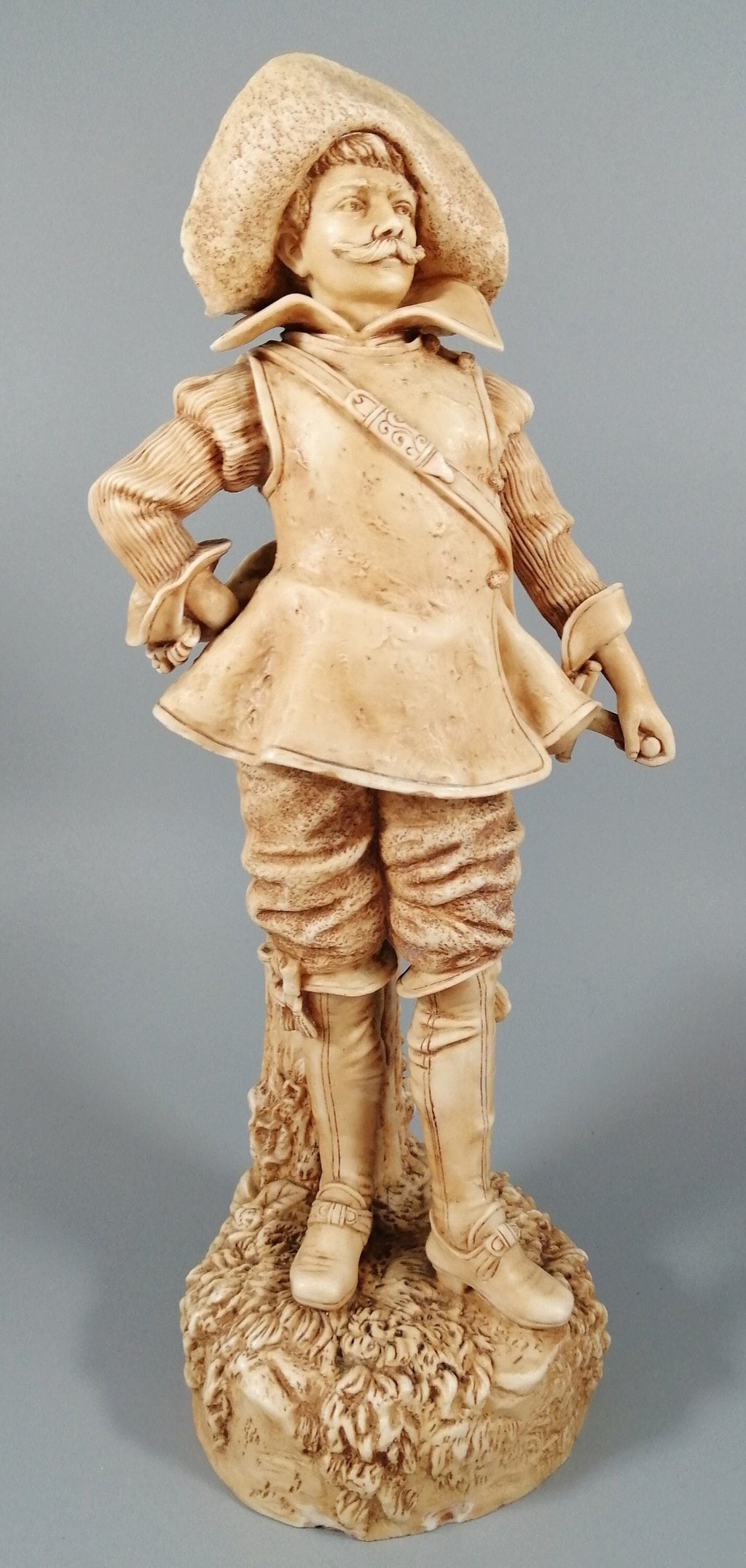 A Robinson and Leadbeater ivory parian ware figure of a musketeer