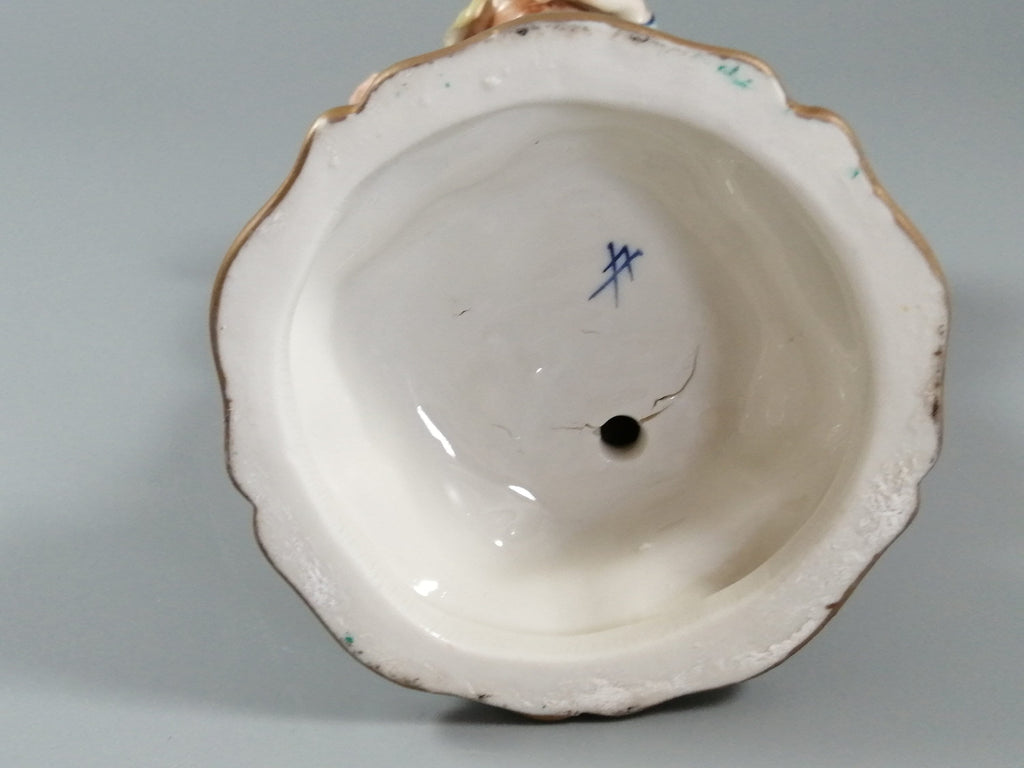 Antique porcelain figurine marked with the crossed swords of Meissen