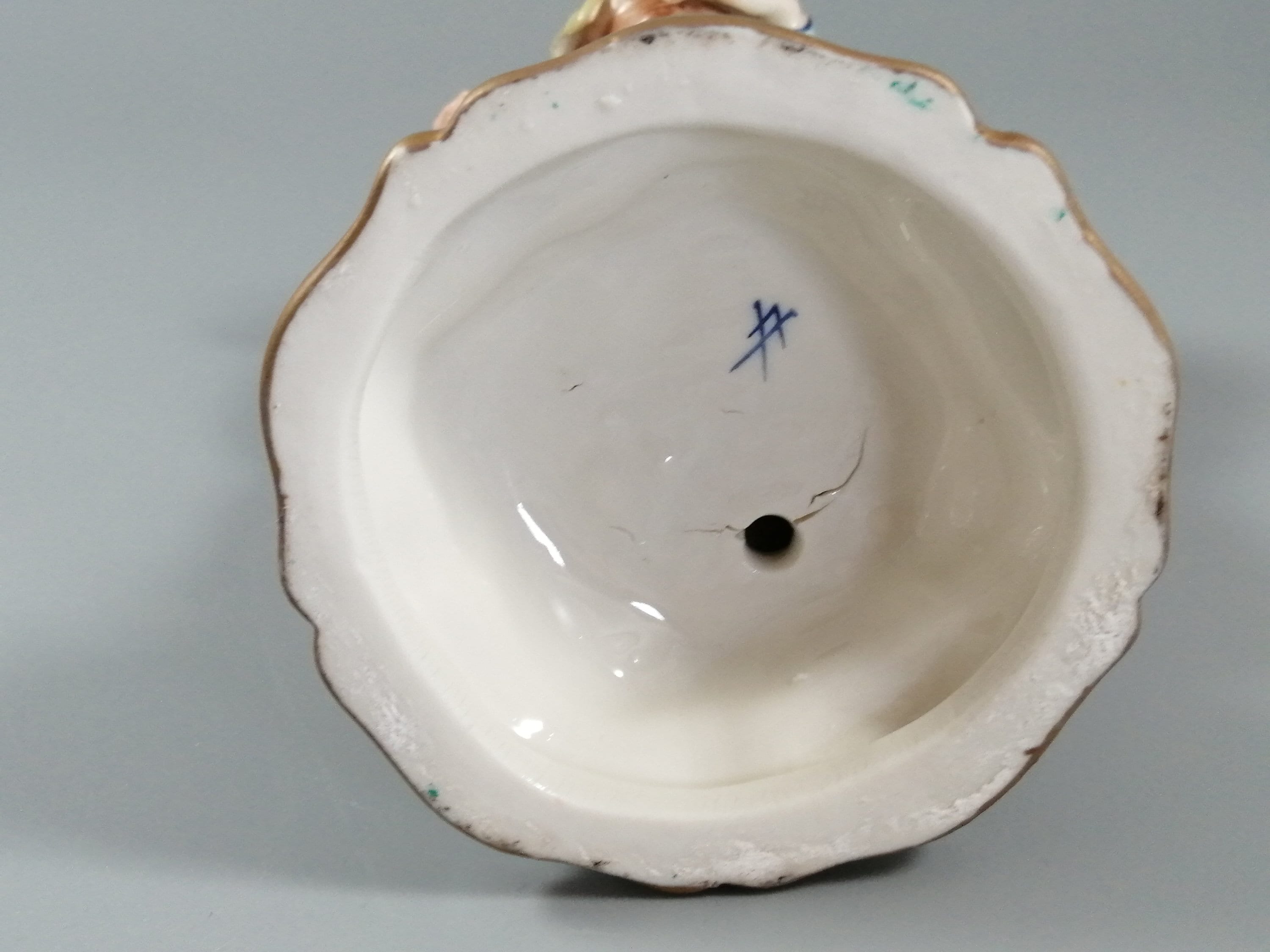 Antique porcelain figurine marked with the crossed swords of Meissen