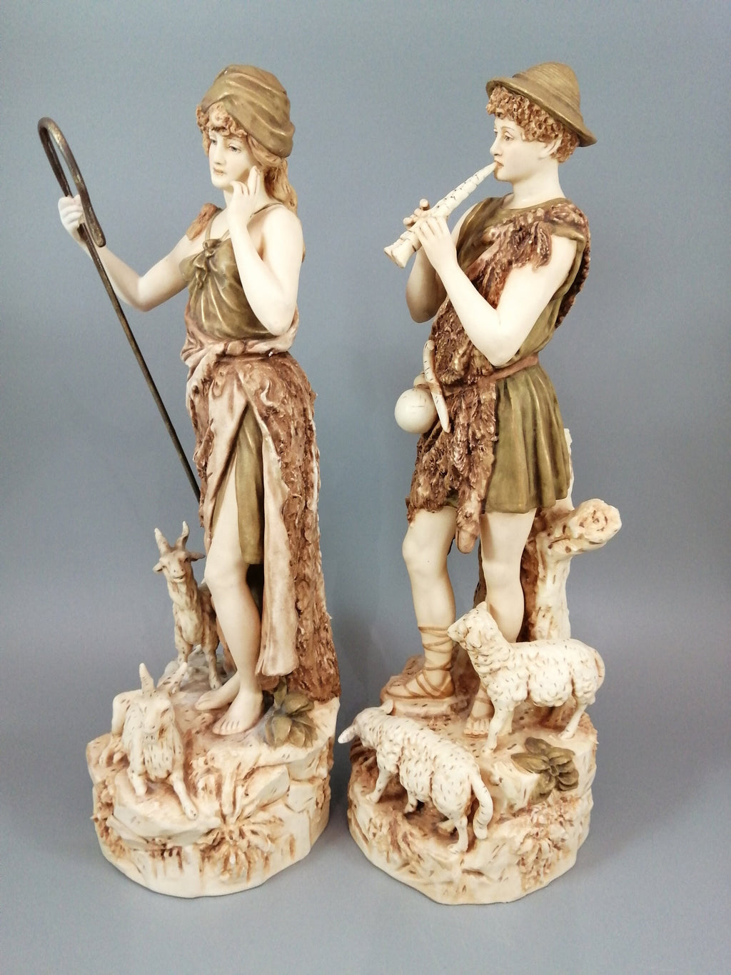 A pair of shepherd and shepherdess statuettes made of Royal Dux porcelain