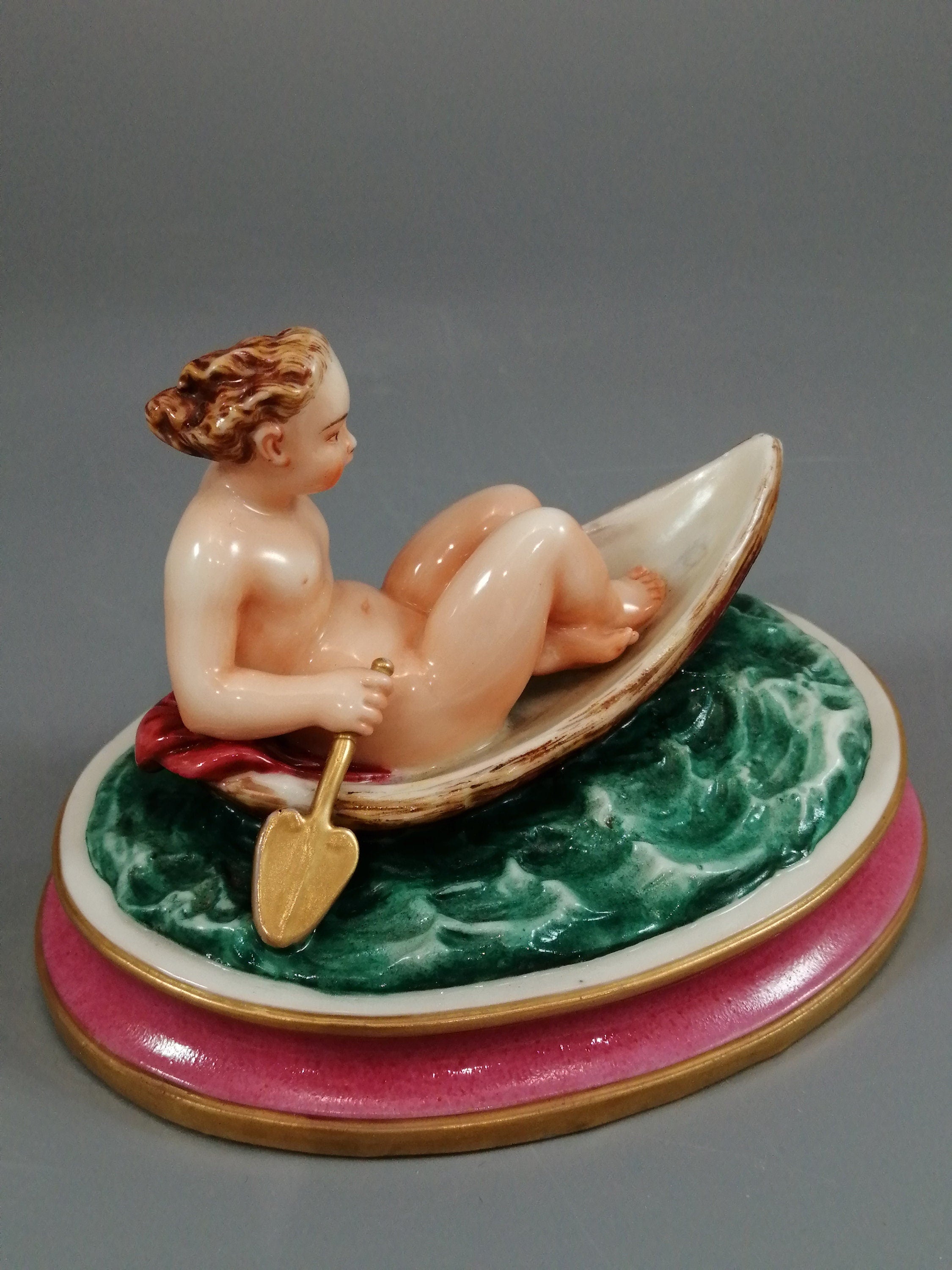 Antique majolica pottery figurine, nude girl in a boat, rare pink-base figure, Minton or French style, gilded oar, 12.8 cm