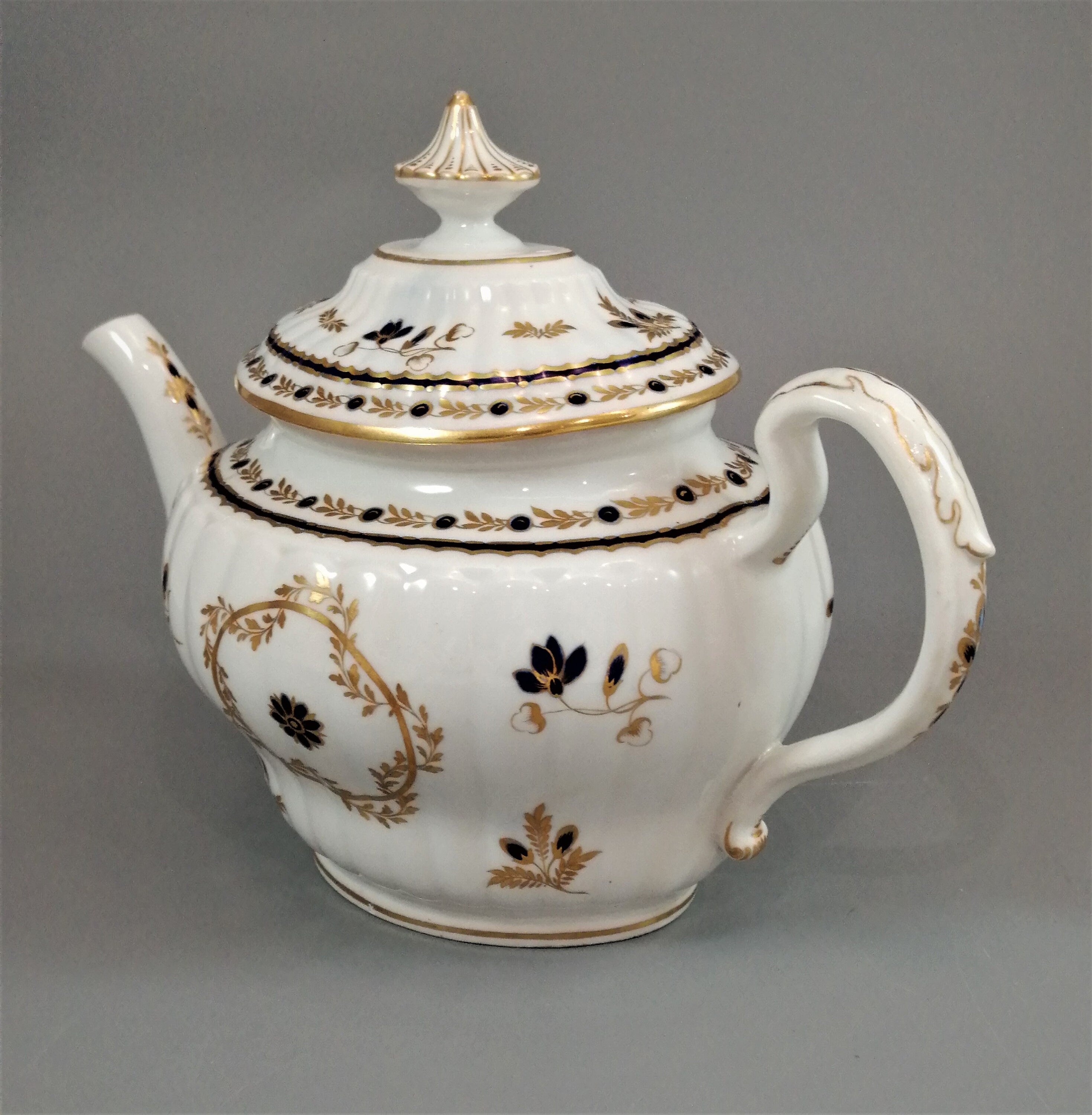 Flight & Barr Worcester barrel-shaped teapot and stand, gold and blue floral design, incised 'M' mark, antique English porcelain, c. 1792