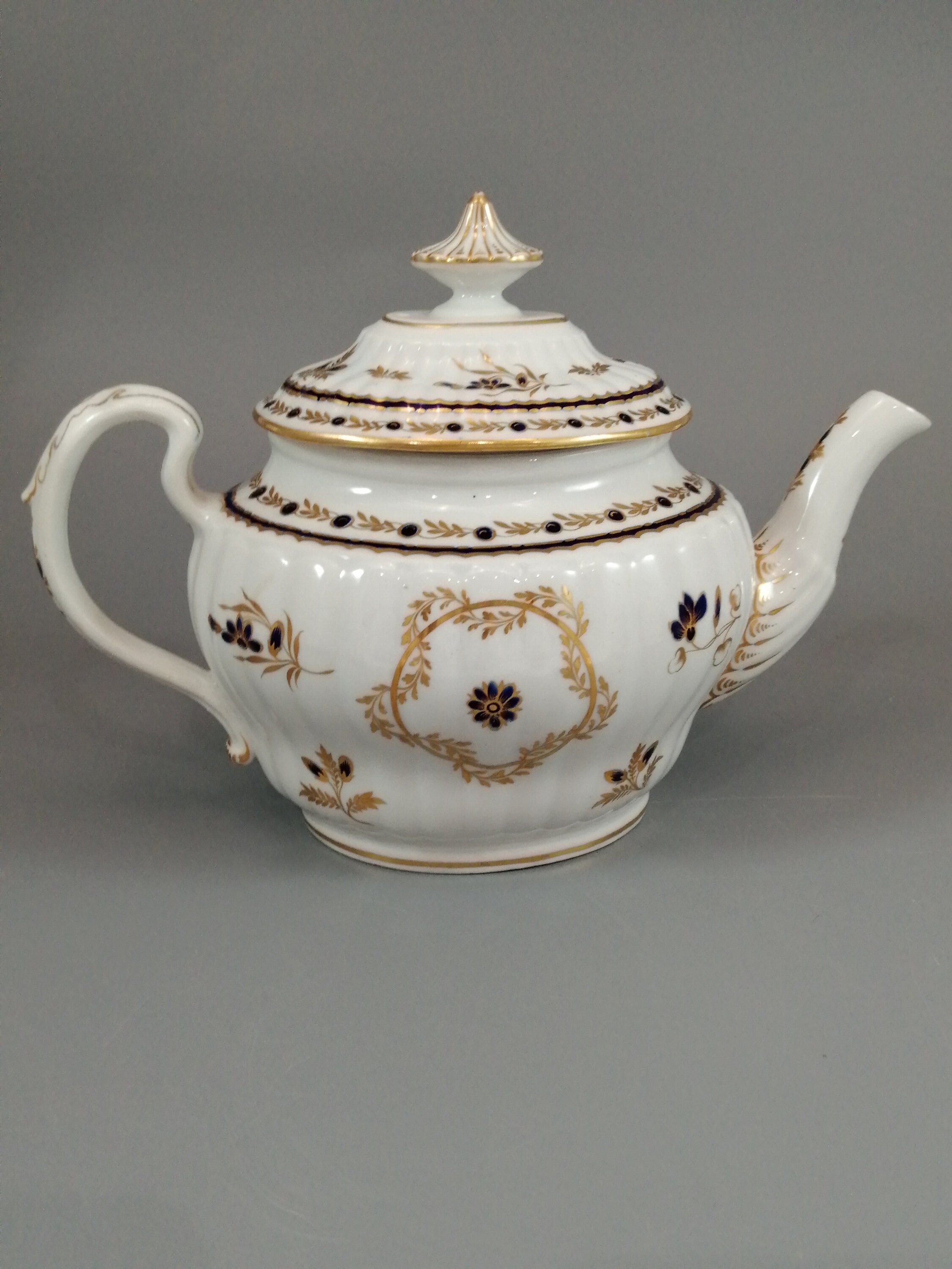 Flight & Barr Worcester barrel-shaped teapot and stand, gold and blue floral design, incised 'M' mark, antique English porcelain, c. 1792