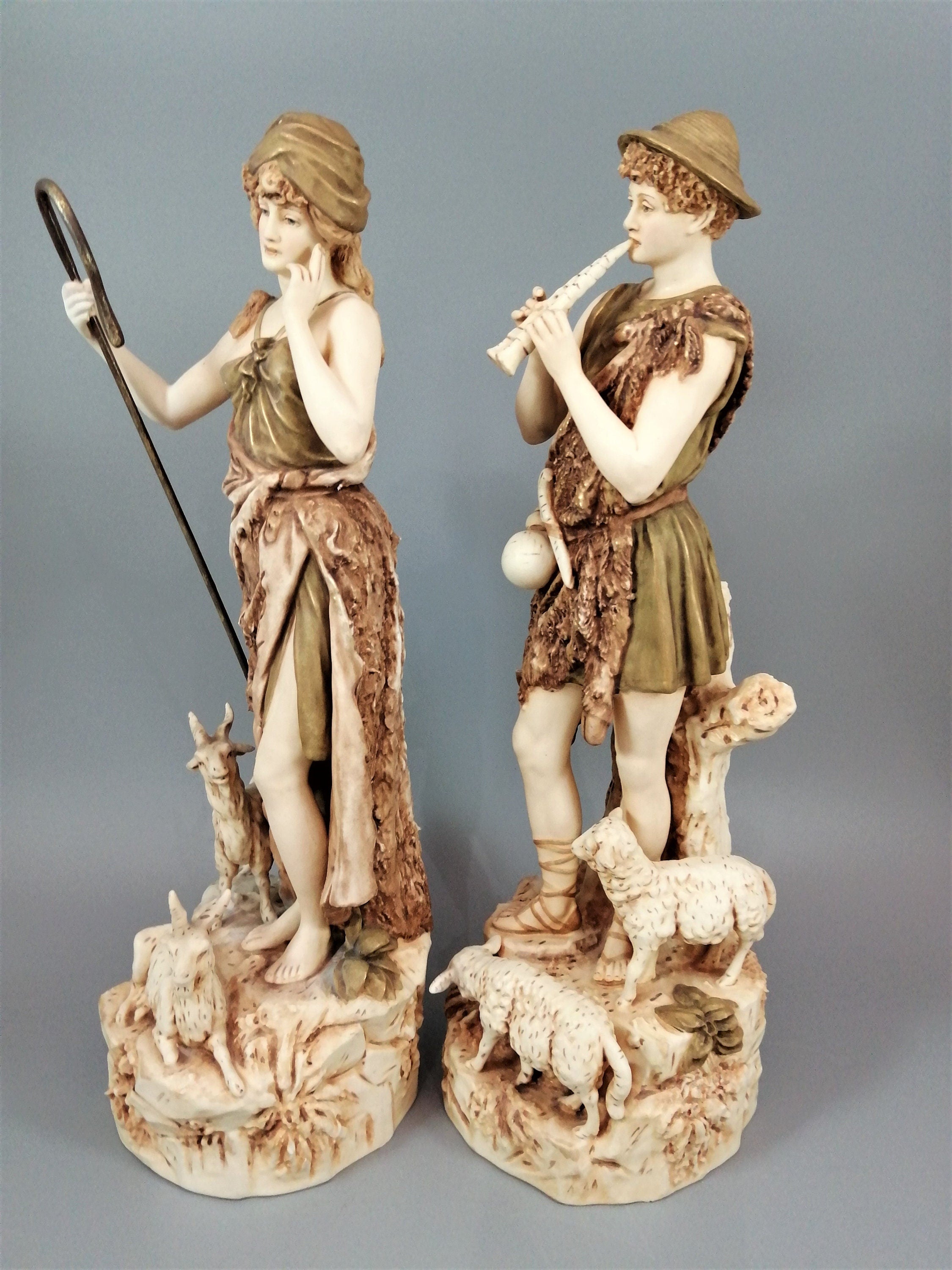 A pair of shepherd and shepherdess statuettes made of Royal Dux porcelain
