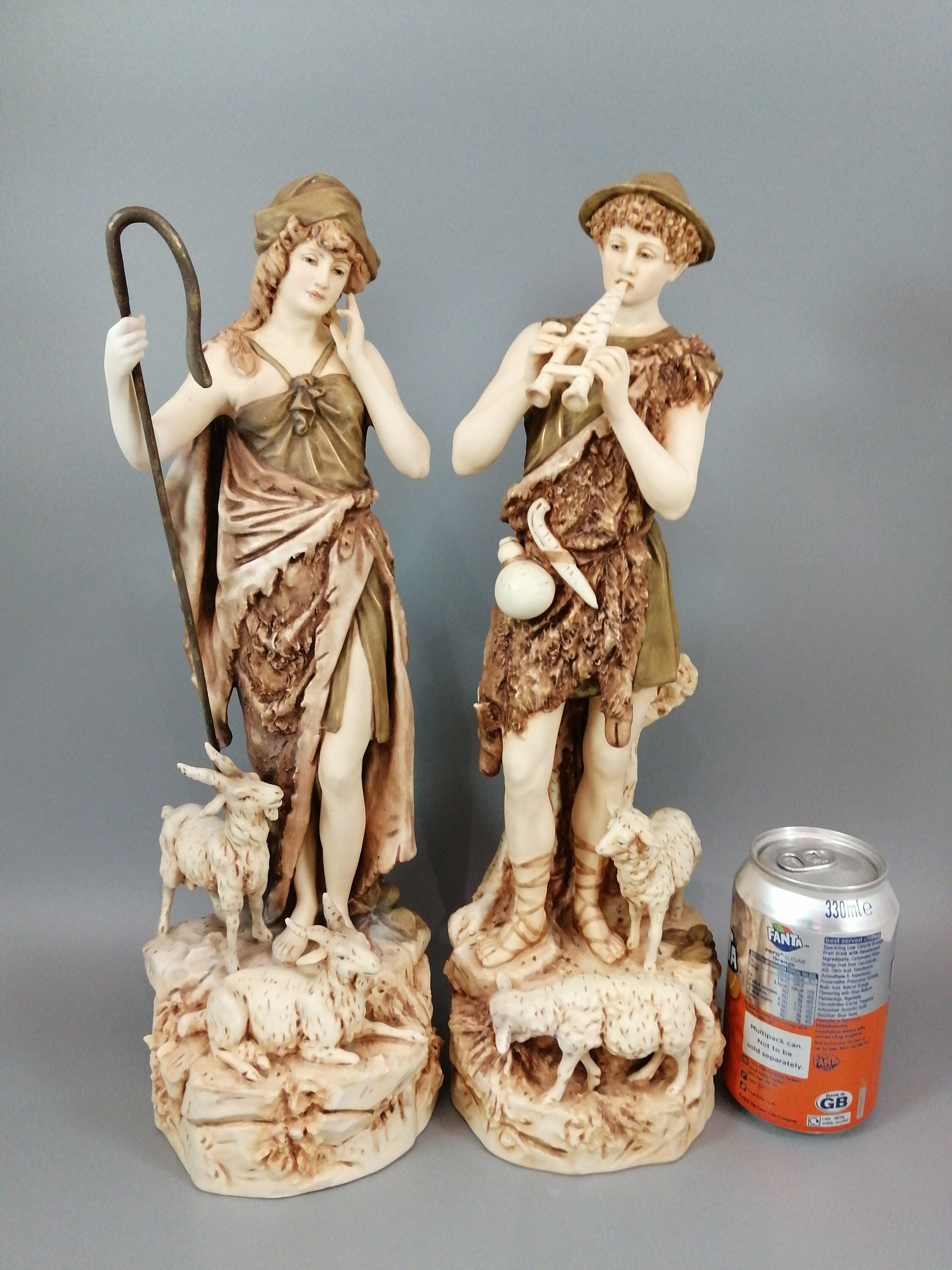 A pair of shepherd and shepherdess statuettes made of Royal Dux porcelain