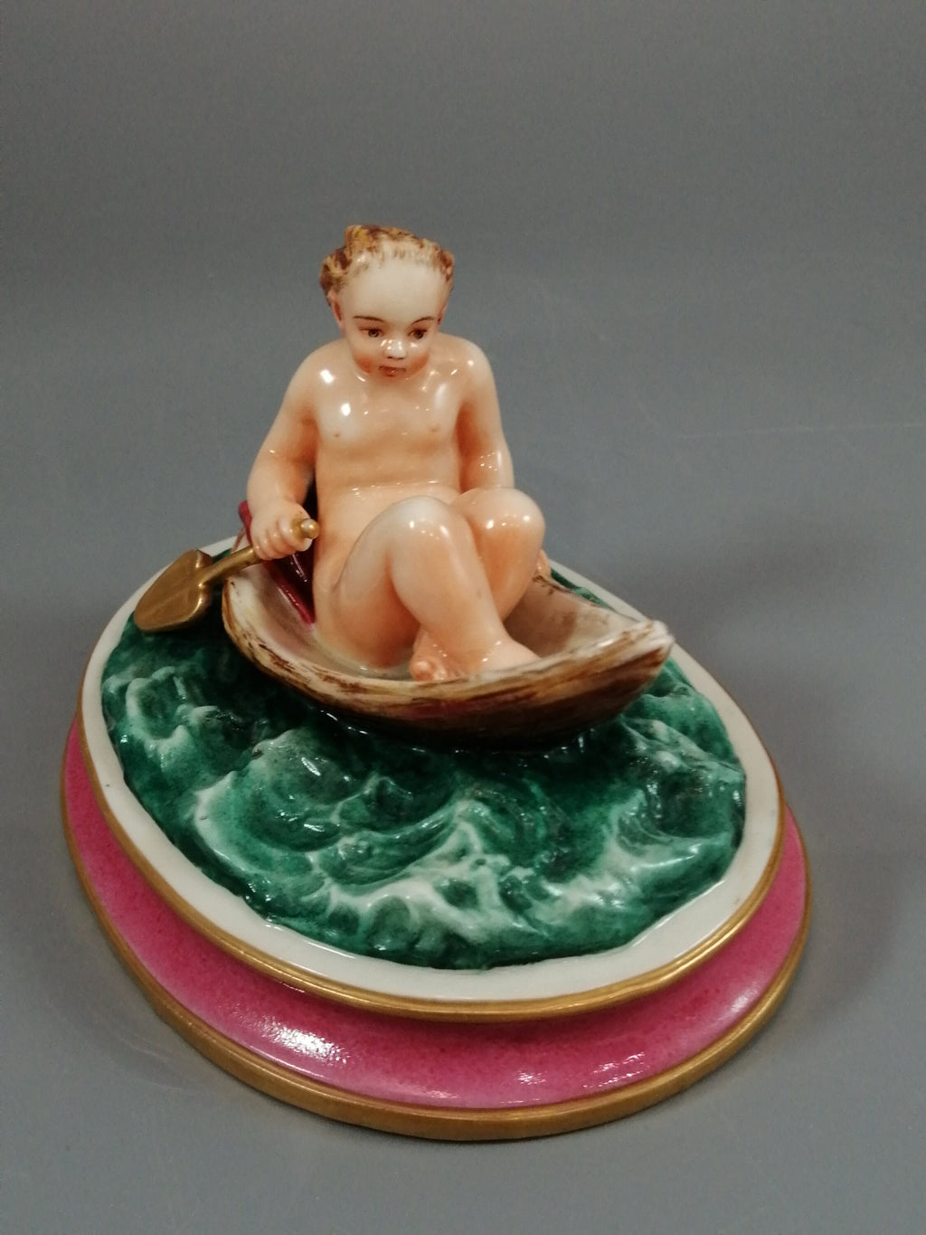 Antique majolica pottery figurine, nude girl in a boat, rare pink-base figure, Minton or French style, gilded oar, 12.8 cm