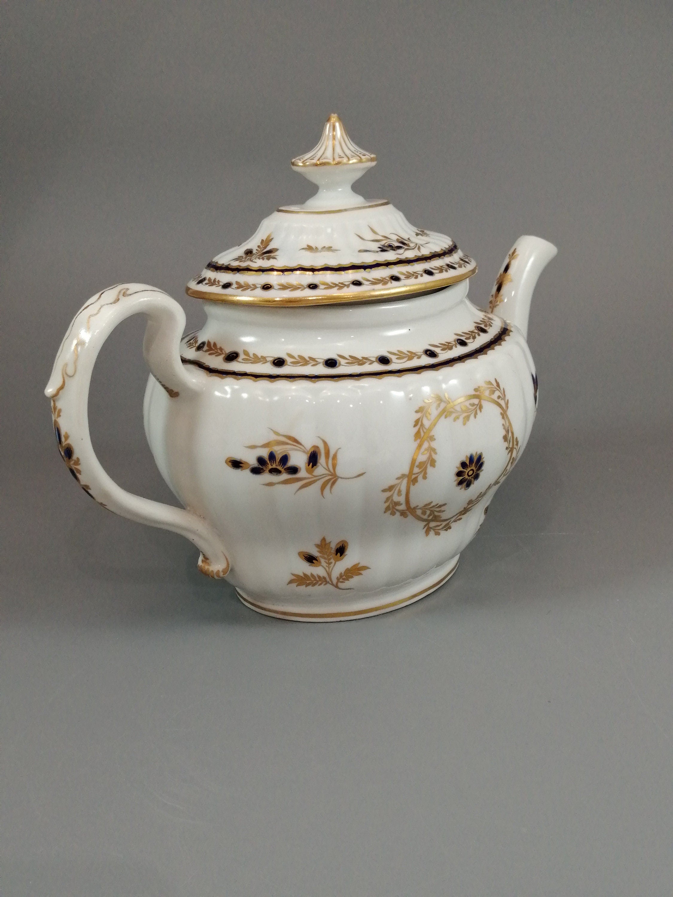 Flight & Barr Worcester barrel-shaped teapot and stand, gold and blue floral design, incised 'M' mark, antique English porcelain, c. 1792