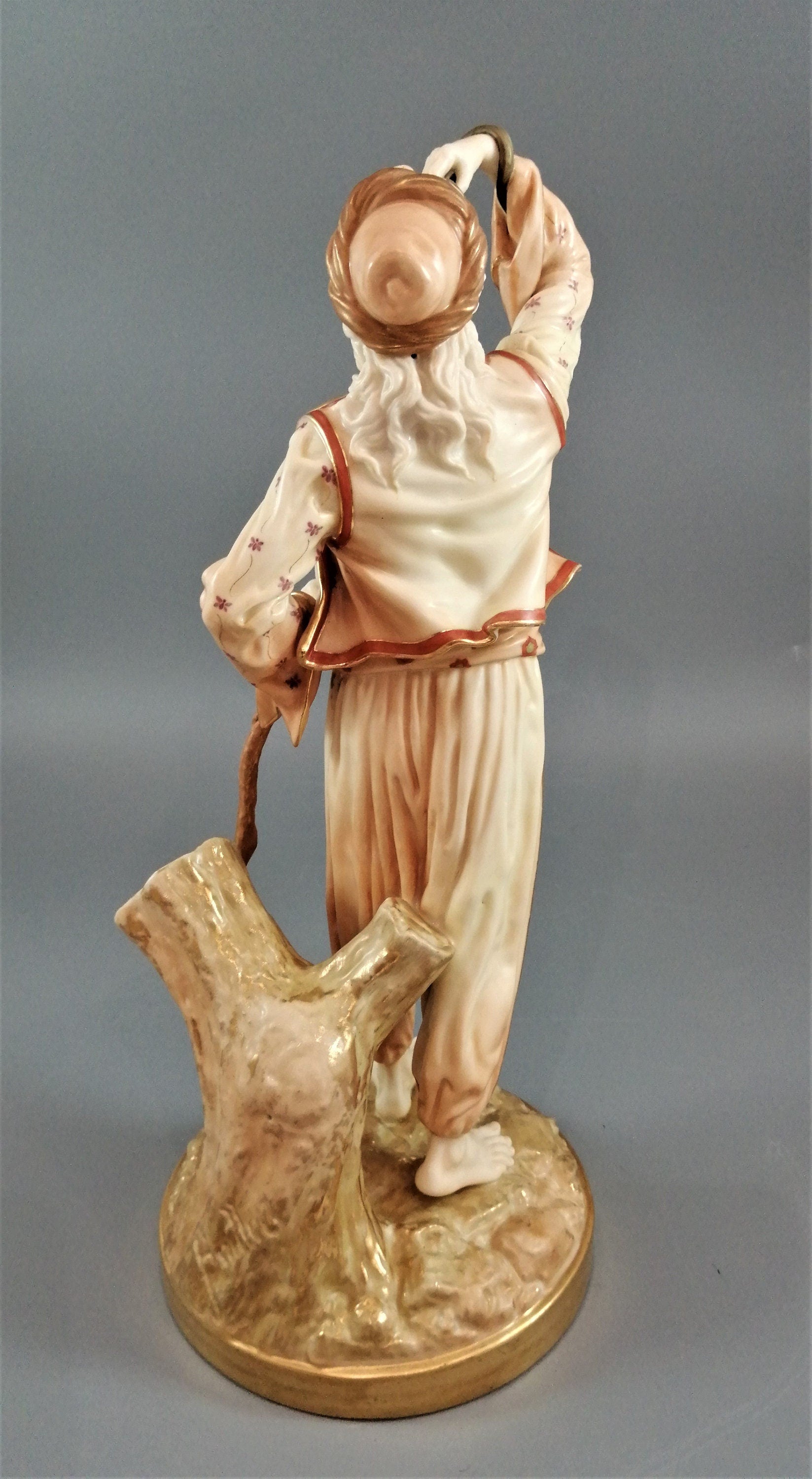 A rare Royal Worcester figurine titled "The Snake Charmer," dated 1898.