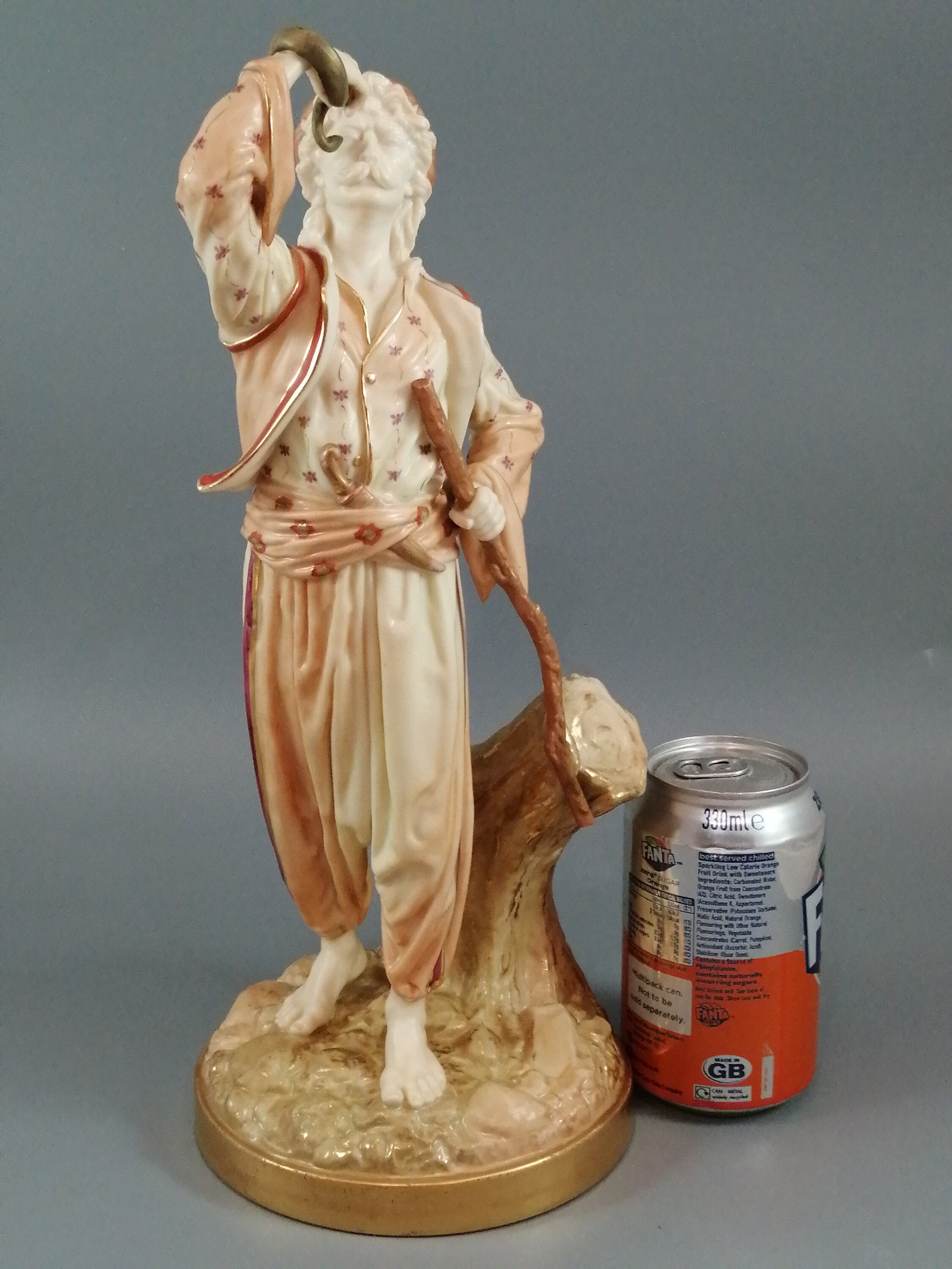 A rare Royal Worcester figurine titled "The Snake Charmer," dated 1898.
