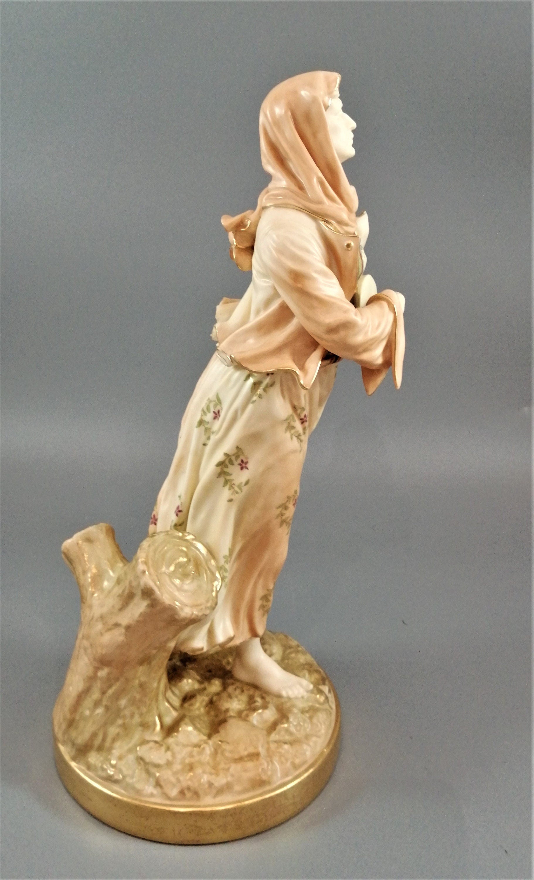 A rare Royal Worcester figurine titled "Musician," depicting a lady with a drum , 1898.