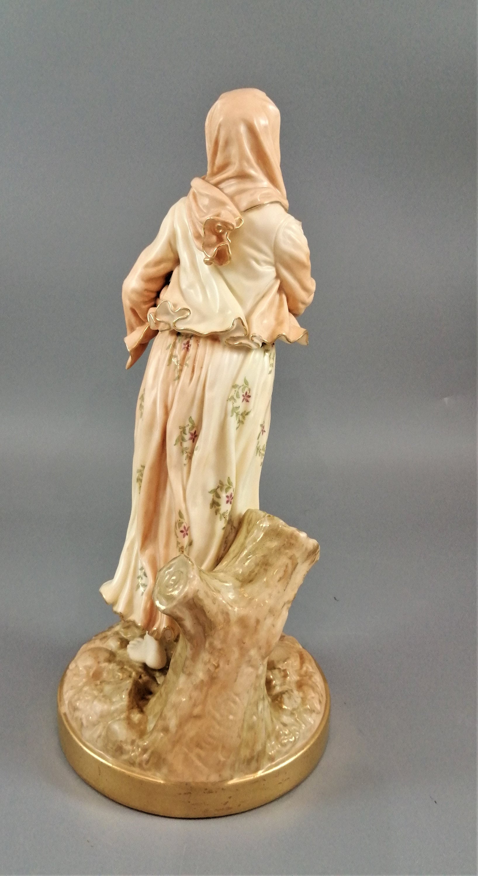 A rare Royal Worcester figurine titled "Musician," depicting a lady with a drum , 1898.