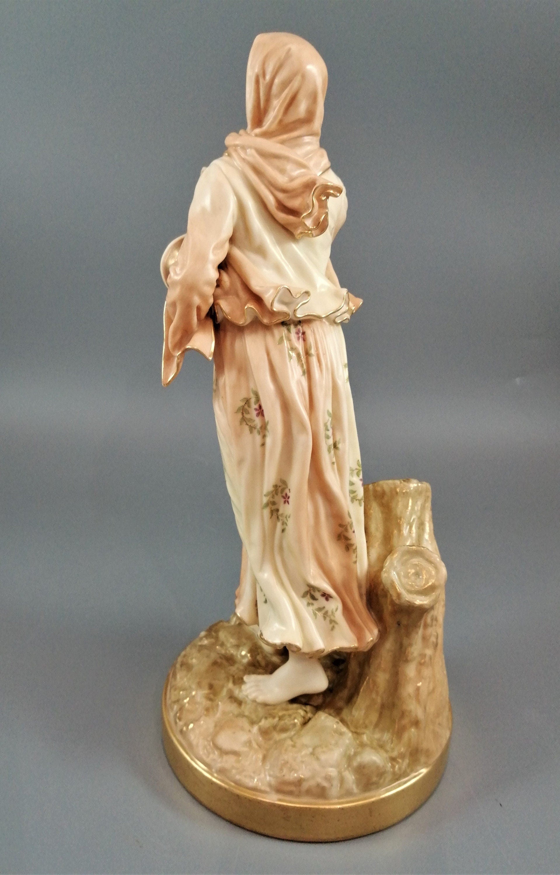 A rare Royal Worcester figurine titled "Musician," depicting a lady with a drum , 1898.