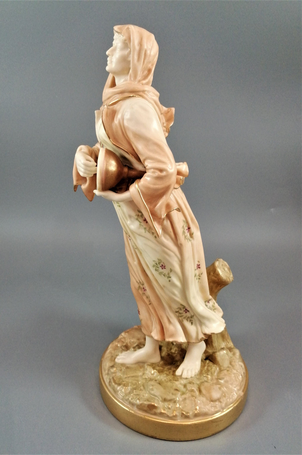 A rare Royal Worcester figurine titled "Musician," depicting a lady with a drum , 1898.