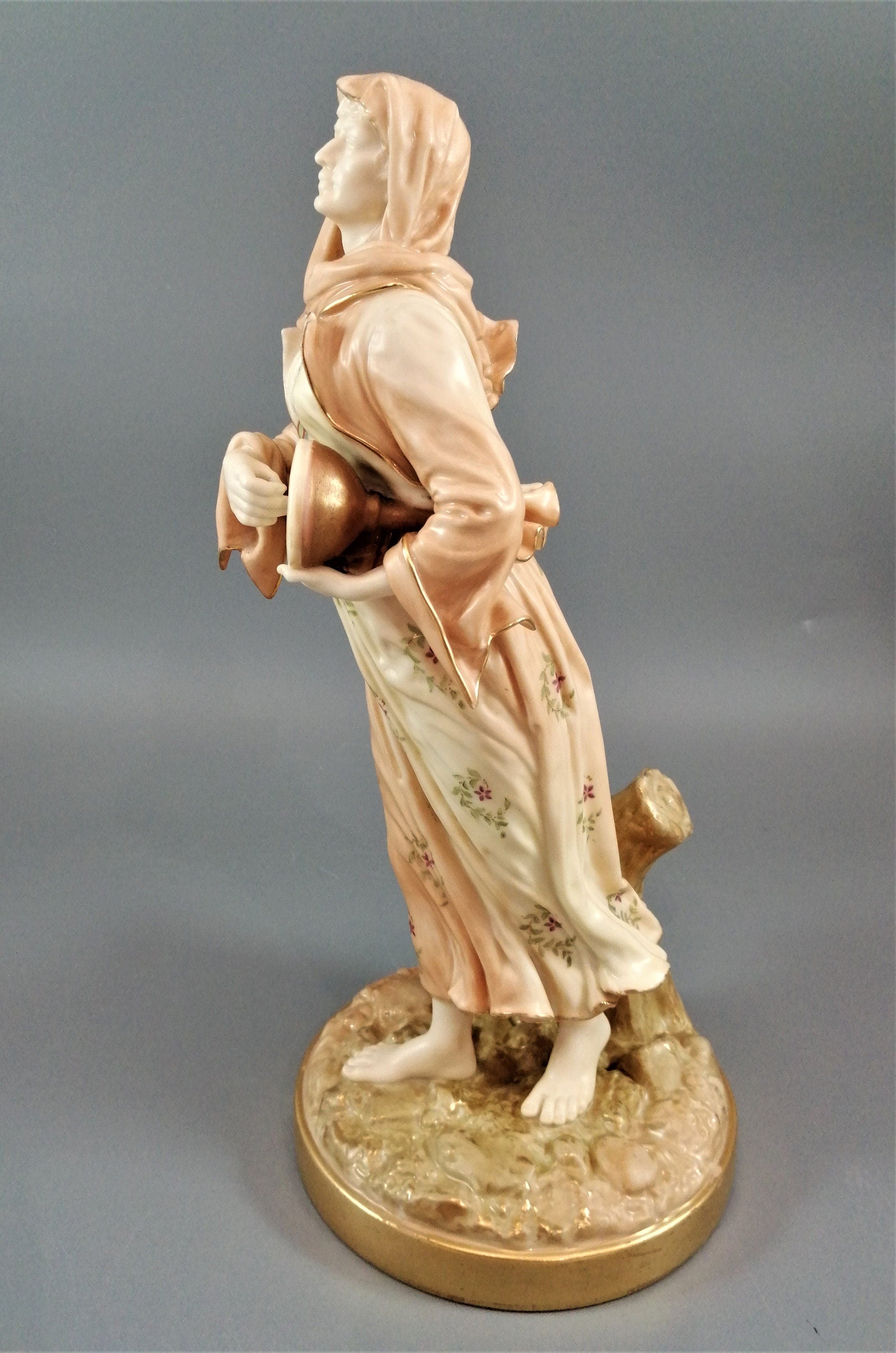 A rare Royal Worcester figurine titled "Musician," depicting a lady with a drum , 1898.