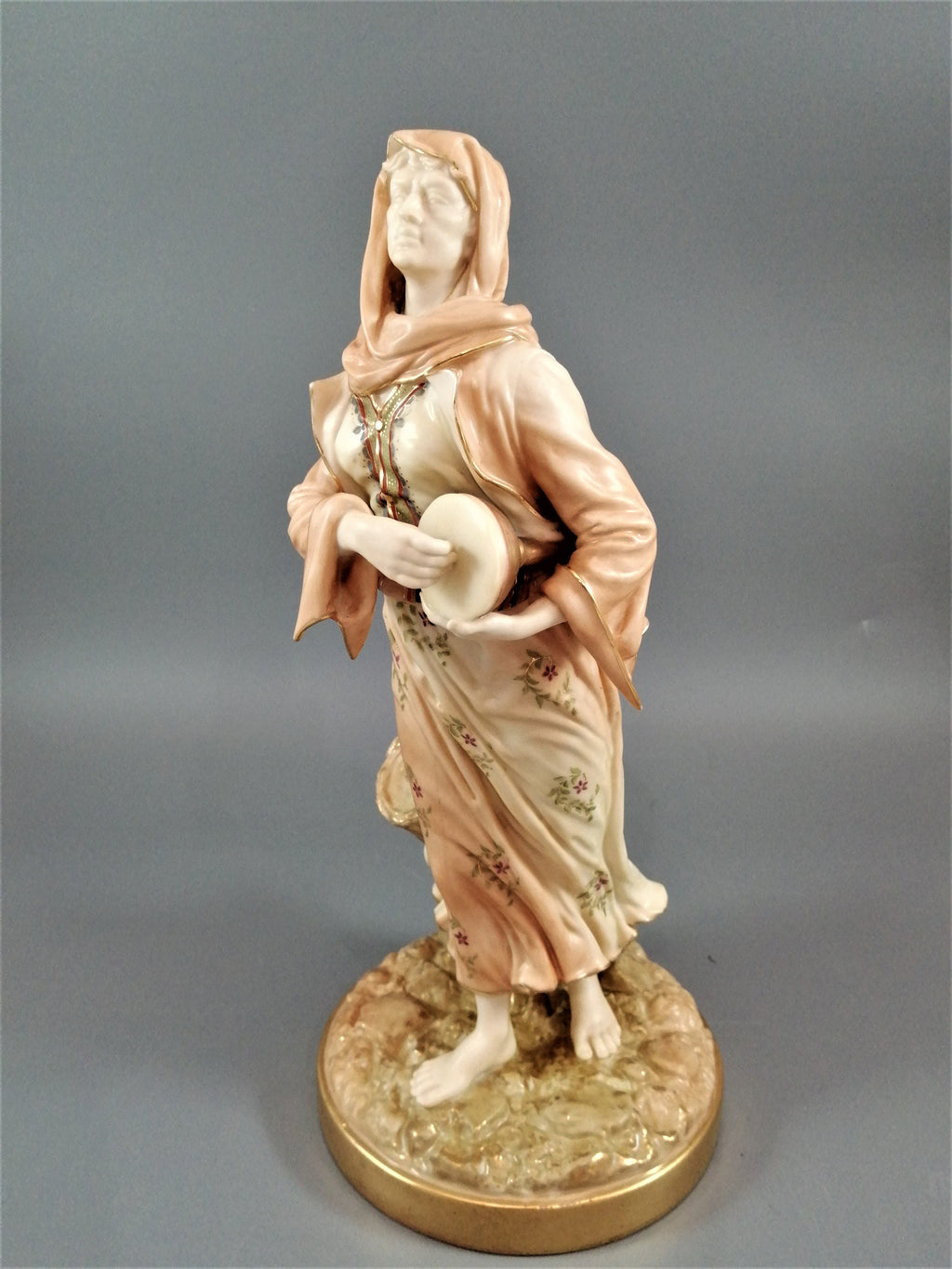 A rare Royal Worcester figurine titled "Musician," depicting a lady with a drum , 1898.
