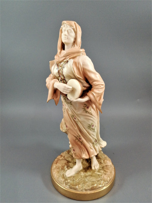 A rare Royal Worcester figurine titled "Musician," depicting a lady with a drum , 1898.