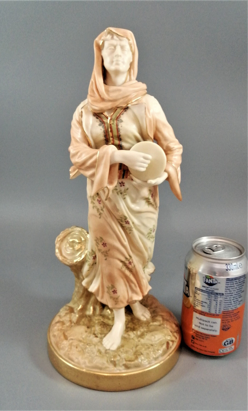 A rare Royal Worcester figurine titled "Musician," depicting a lady with a drum , 1898.