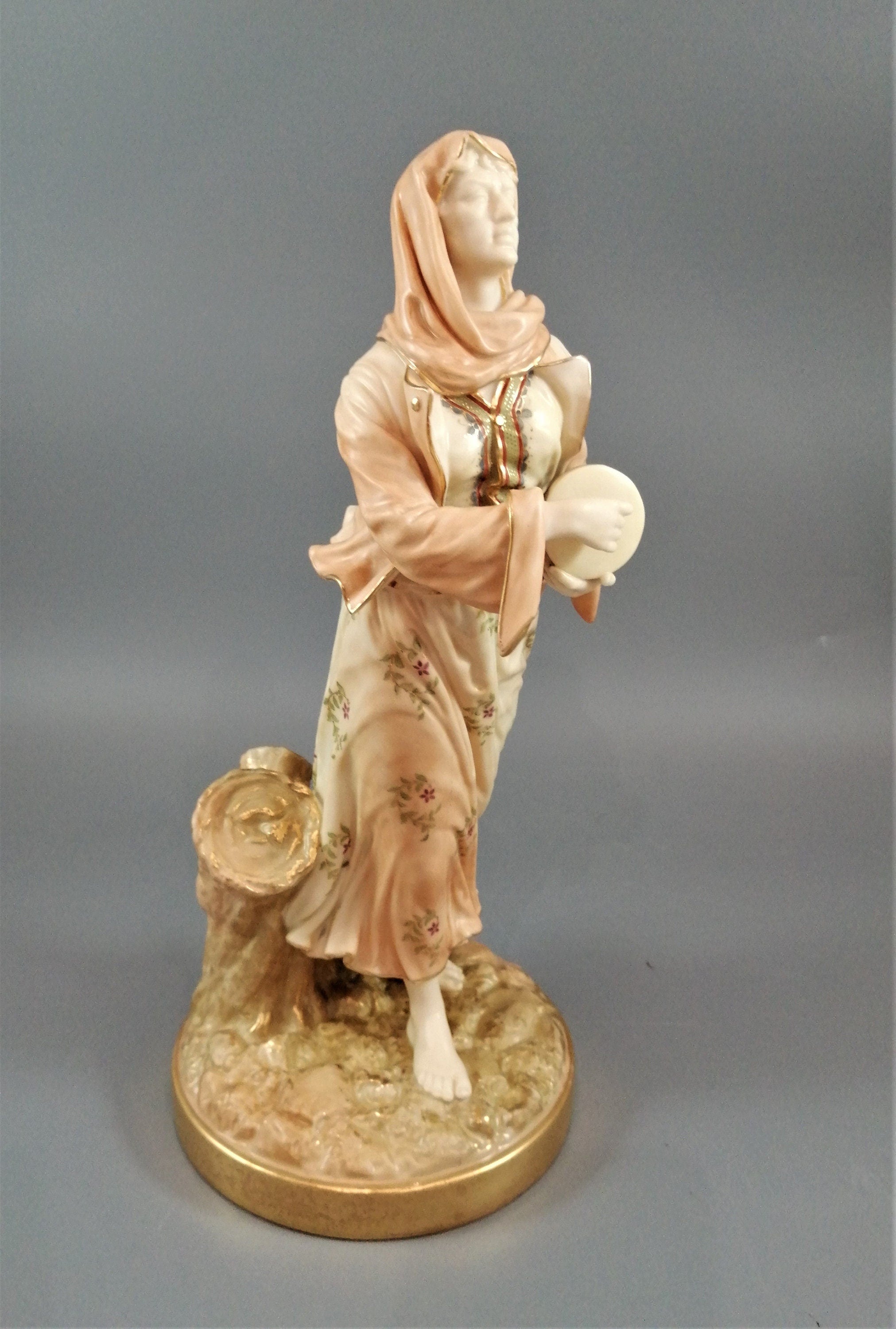 A rare Royal Worcester figurine titled "Musician," depicting a lady with a drum , 1898.