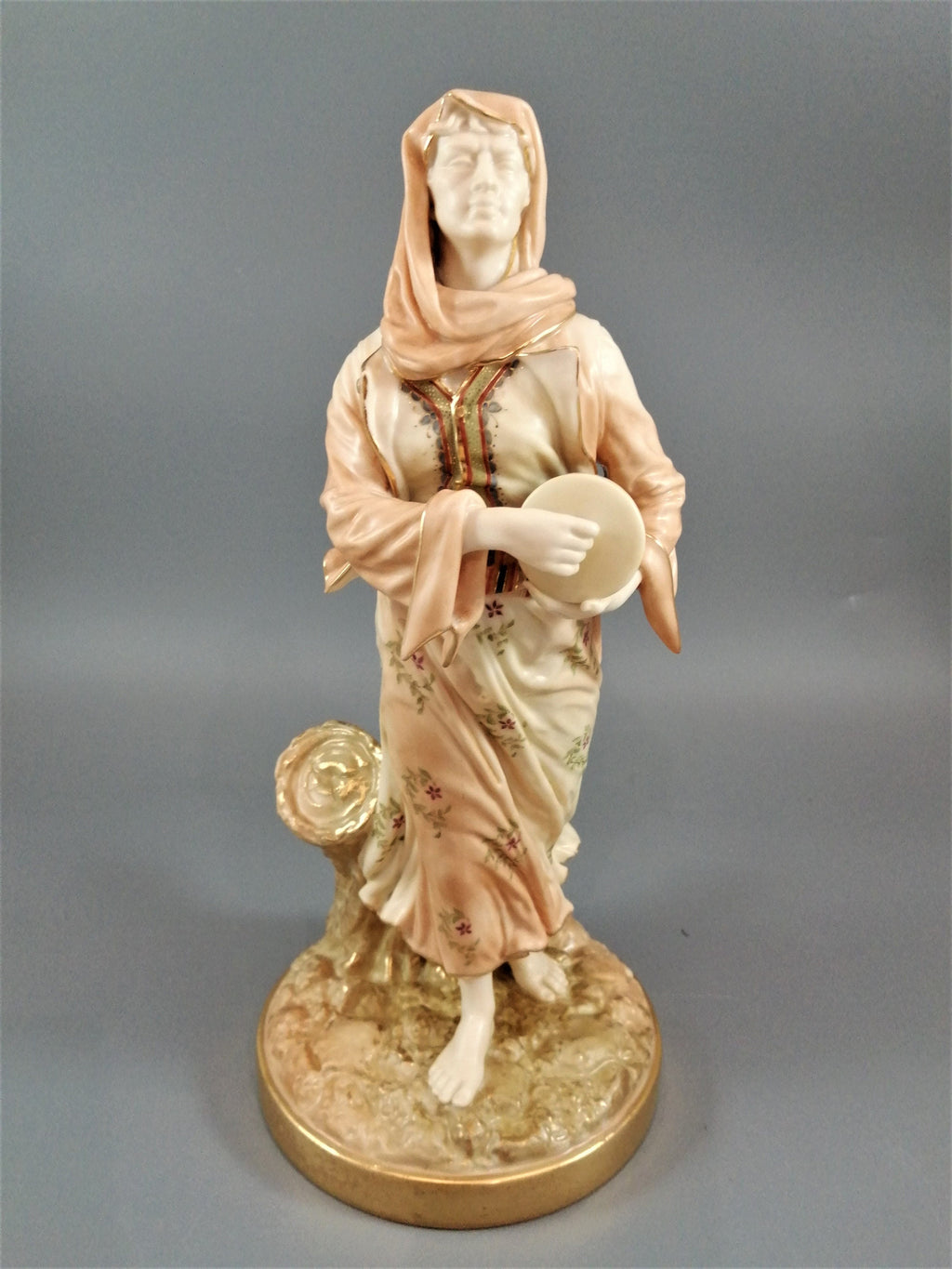 A rare Royal Worcester figurine titled "Musician," depicting a lady with a drum , 1898.