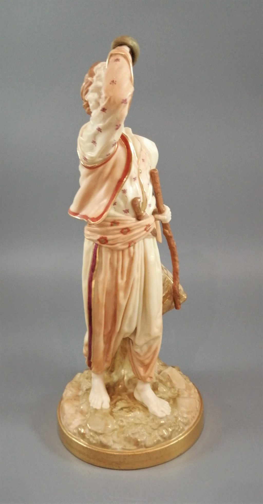A rare Royal Worcester figurine titled "The Snake Charmer," dated 1898.