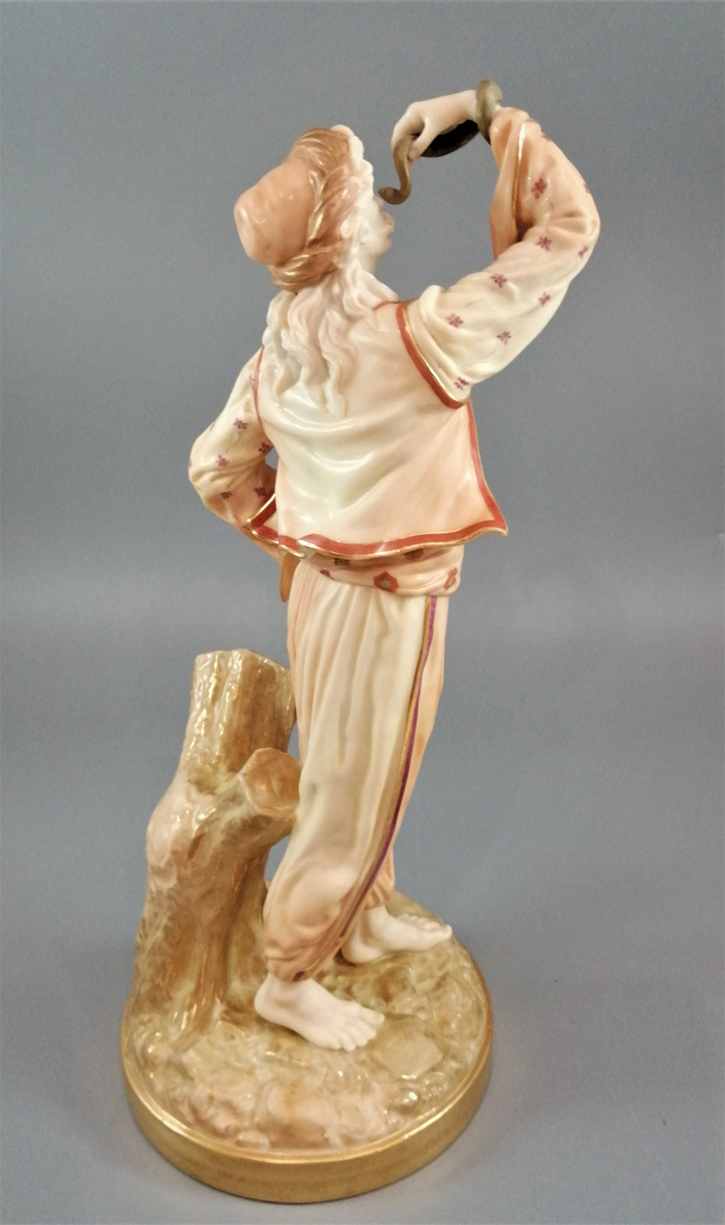 A rare Royal Worcester figurine titled "The Snake Charmer," dated 1898.