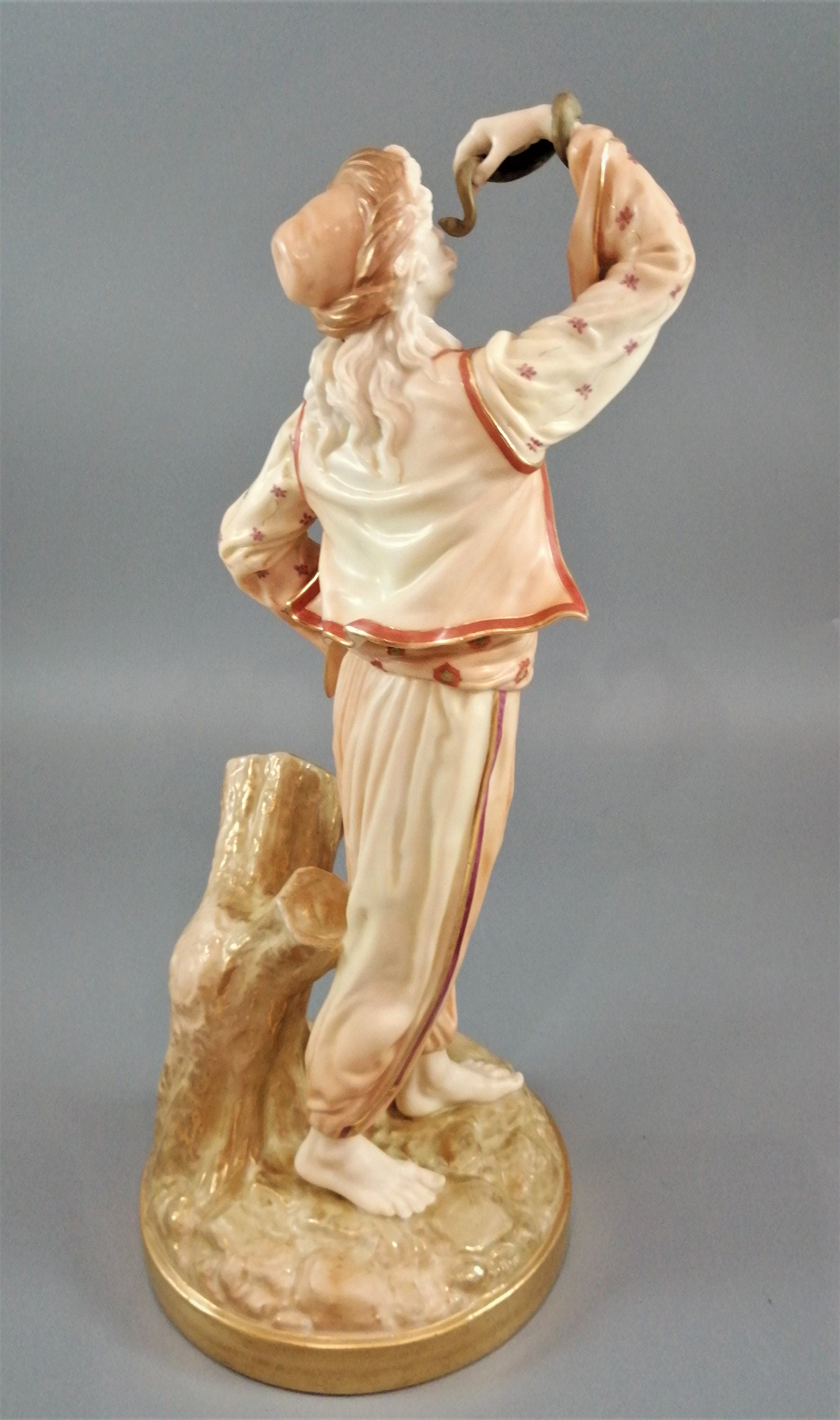 A rare Royal Worcester figurine titled "The Snake Charmer," dated 1898.