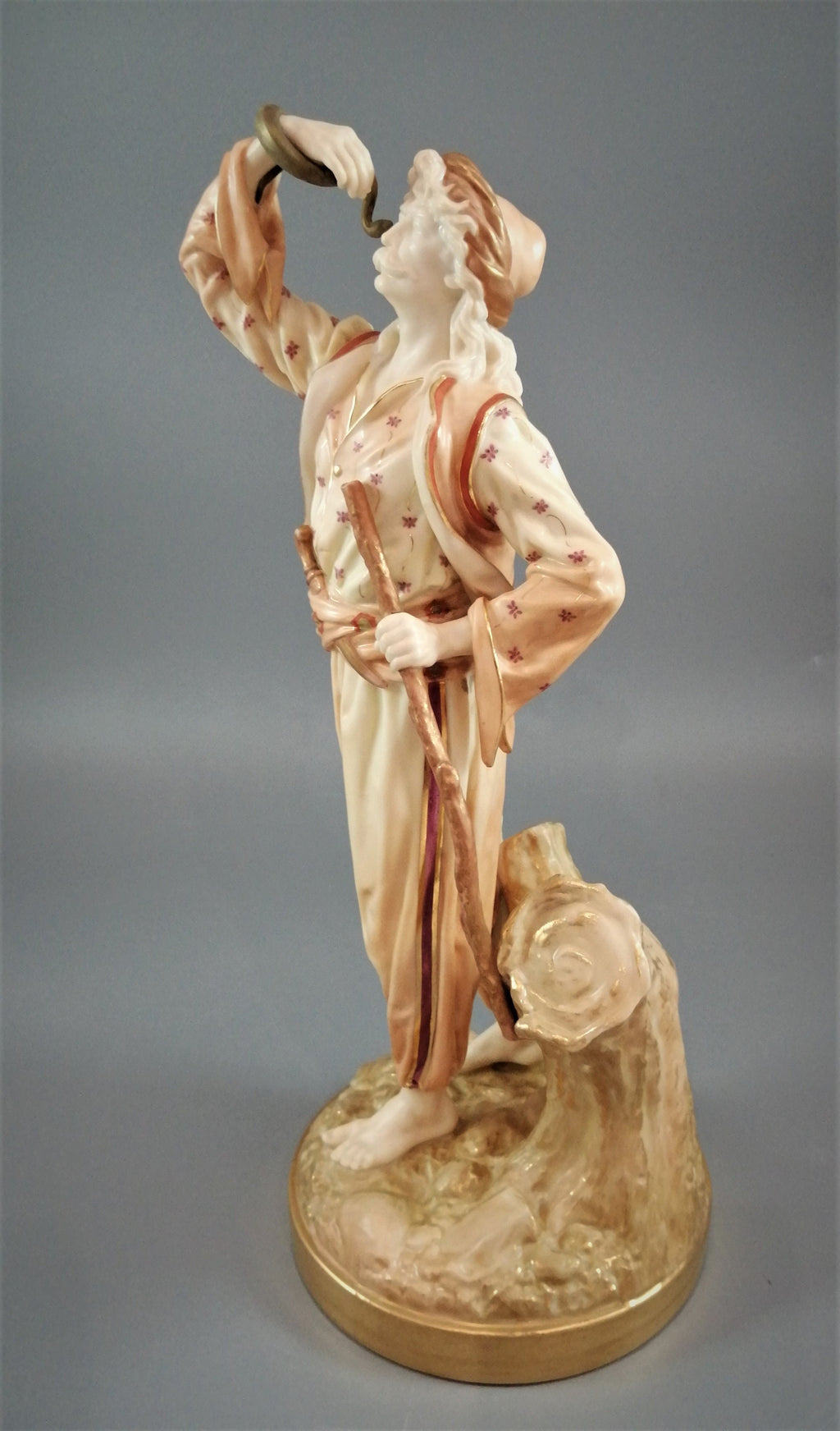 A rare Royal Worcester figurine titled "The Snake Charmer," dated 1898.
