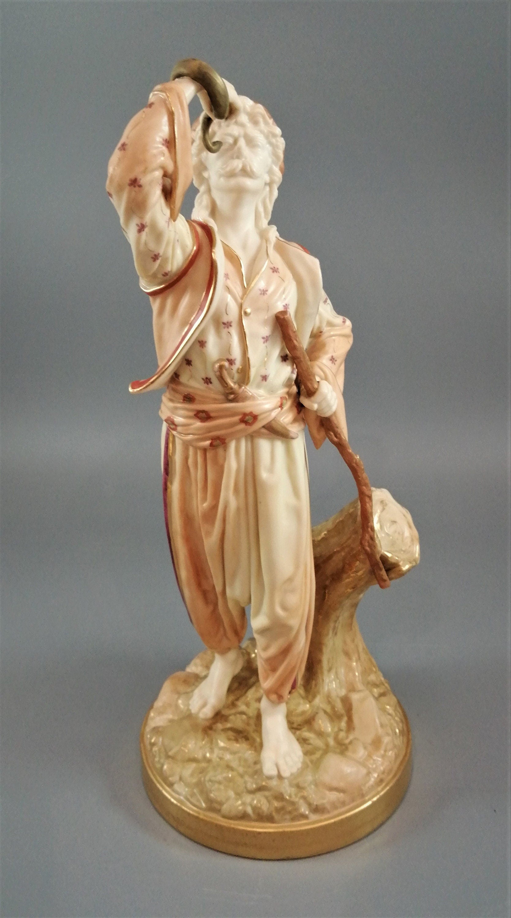 A rare Royal Worcester figurine titled "The Snake Charmer," dated 1898.