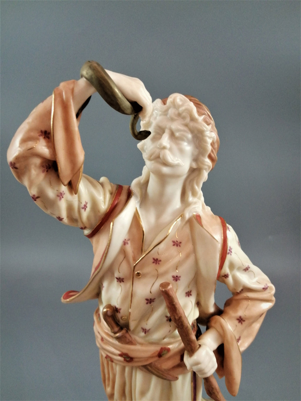 A rare Royal Worcester figurine titled "The Snake Charmer," dated 1898.
