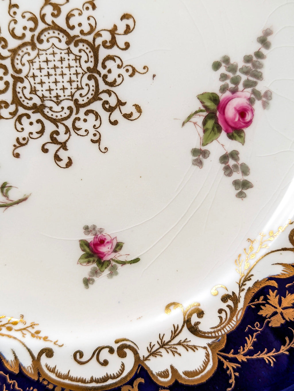 Antique hand painted Coalport plate with floral and gilt decoration.