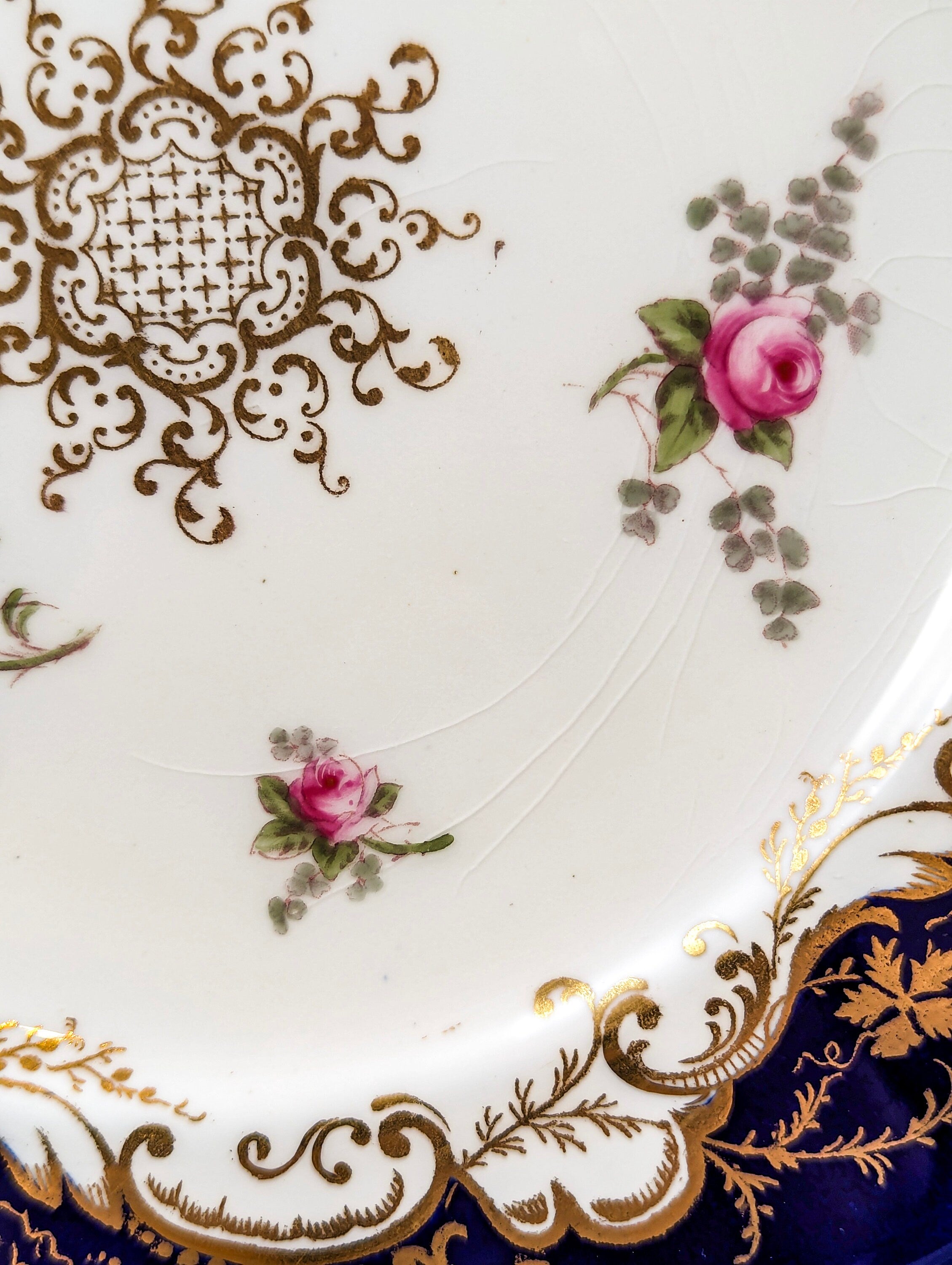 Antique hand painted Coalport plate with floral and gilt decoration.