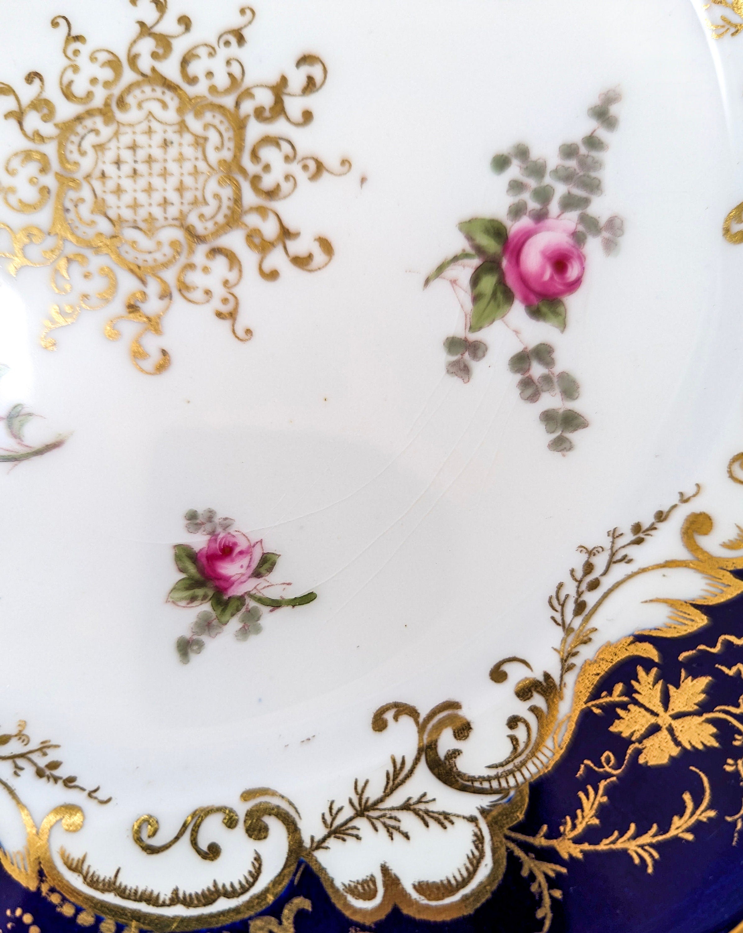 Antique hand painted Coalport plate with floral and gilt decoration.
