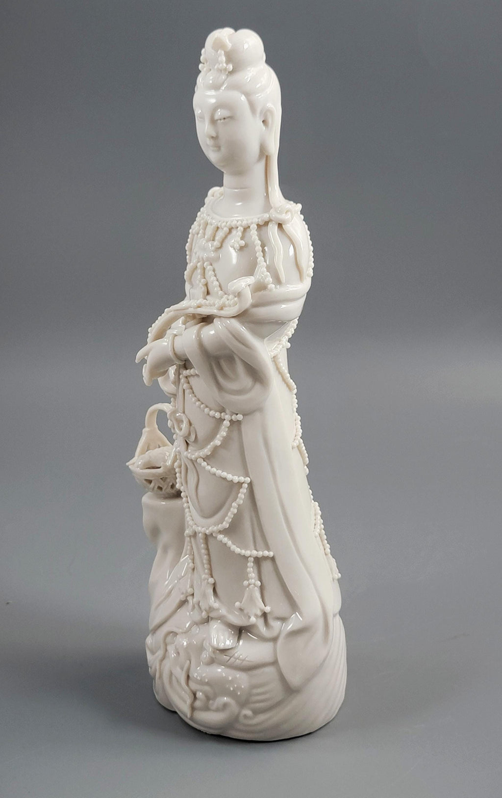 Dehua Blanc de Chine Guanyin with Fish Basket & Dragon Base, early 20th c