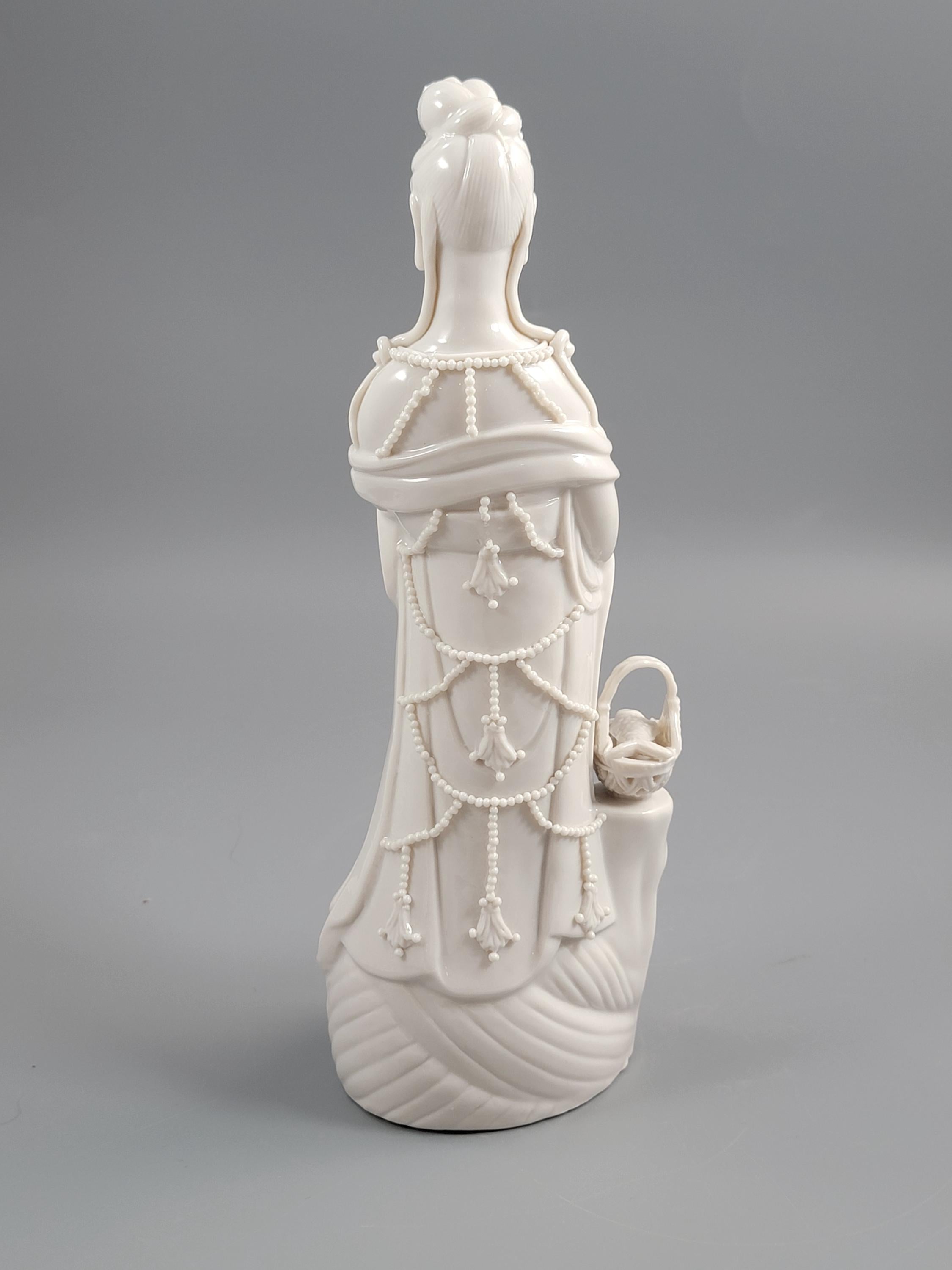 Dehua Blanc de Chine Guanyin with Fish Basket & Dragon Base, early 20th c