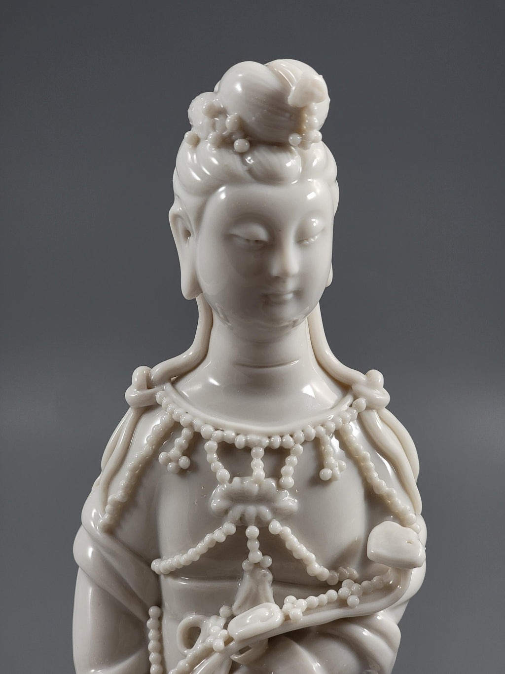 Dehua Blanc de Chine Guanyin with Fish Basket & Dragon Base, early 20th c